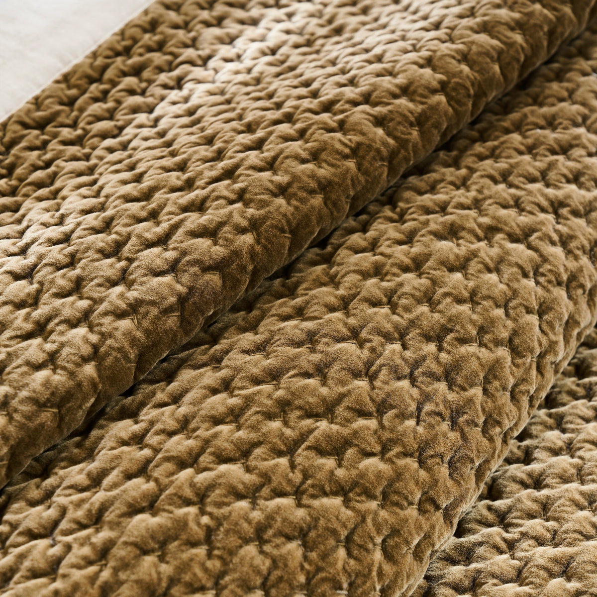 QT-378-11096_7|Detailed close-up of luxurious golden-brown quilted fabric, showcasing its rich, intricate textured pattern.