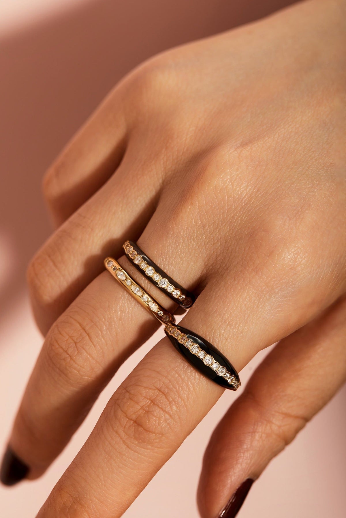 Hand wearing a stylish Multi Shaped CZ Channel Ring showcasing unique ring designs