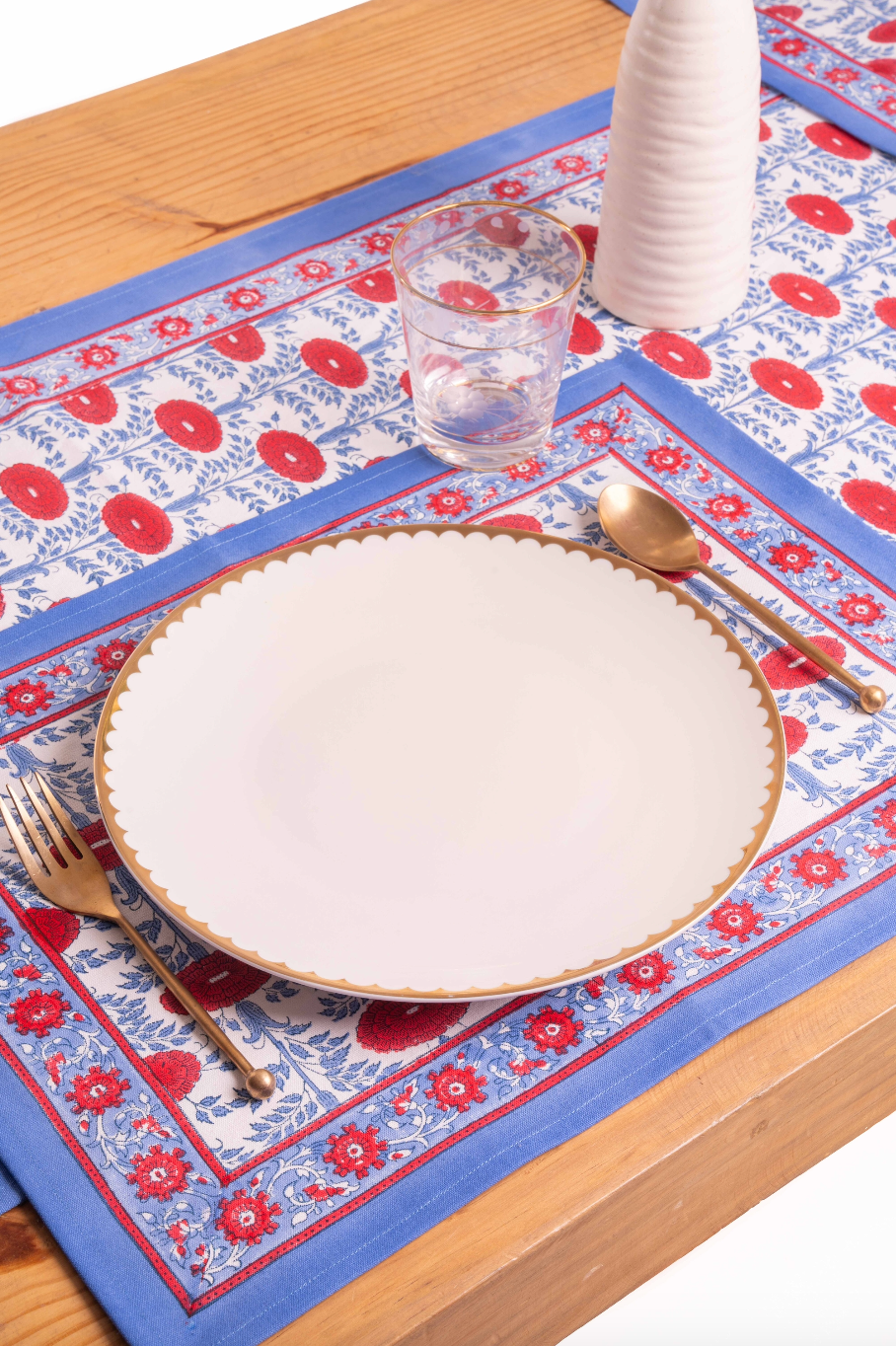 Inner Child Araminta Blockprint placemat with blue/red floral design on wooden table