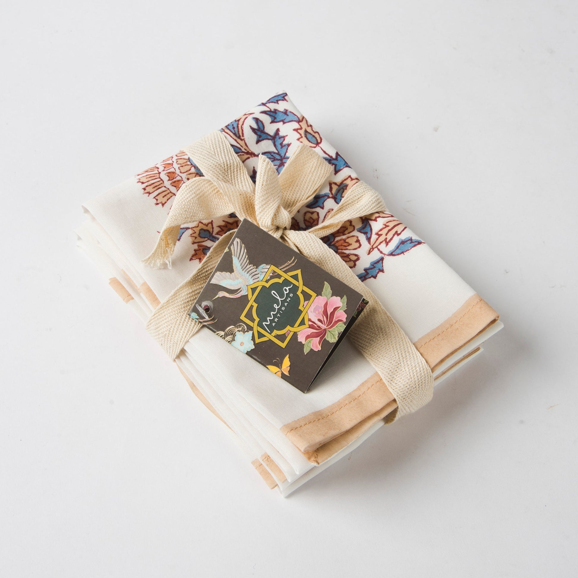 Handcrafted ivory and peach floral cotton napkins for elegant spring table decor.