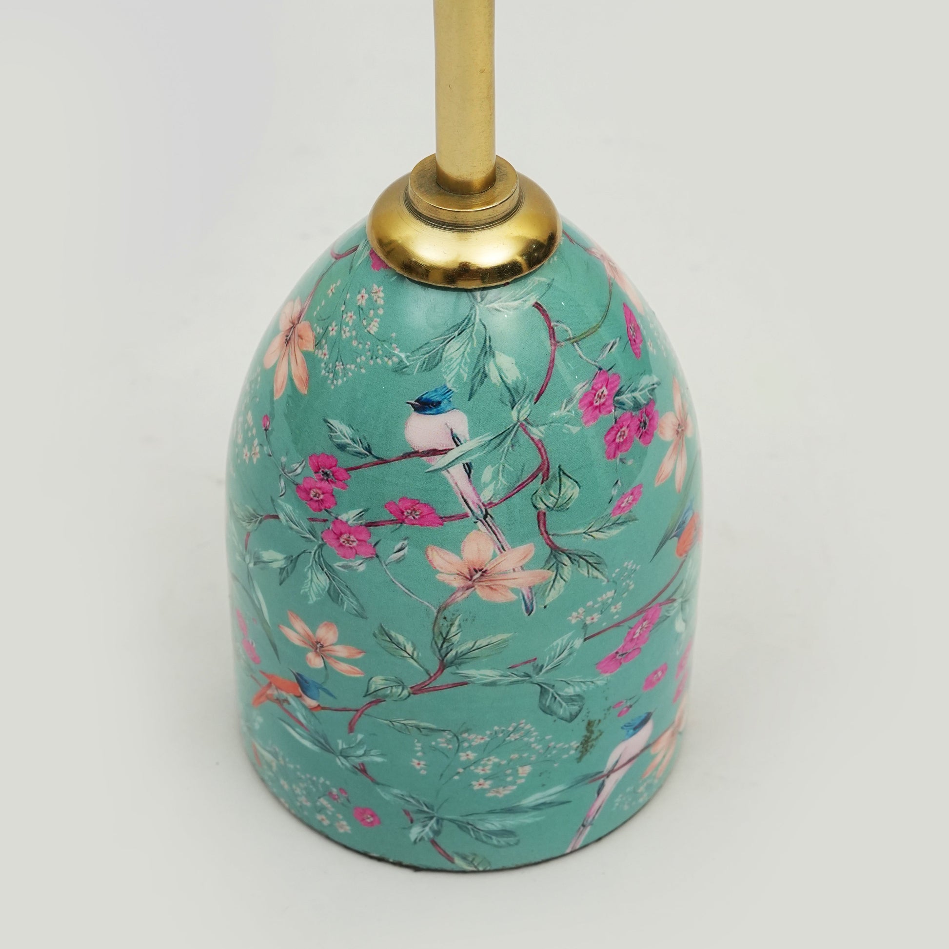 Focus on the smooth gold-toned finish of the metal stem and the artisanal texture of the floral inlay.