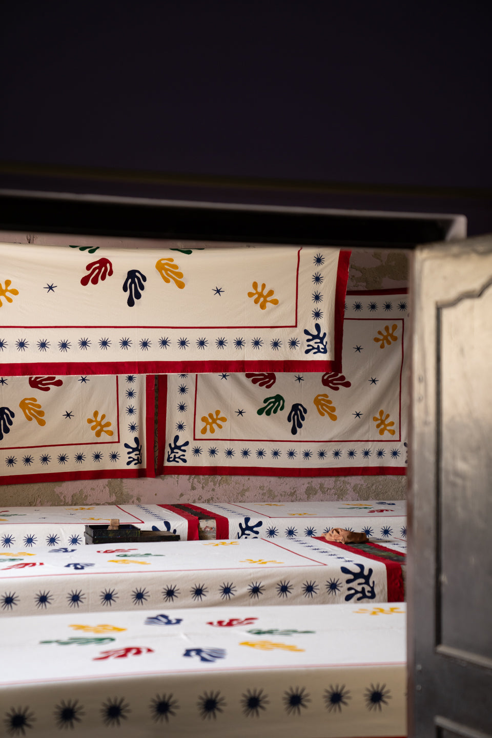 Multiple Celestial Matisse blockprint tablecloths displayed in studio