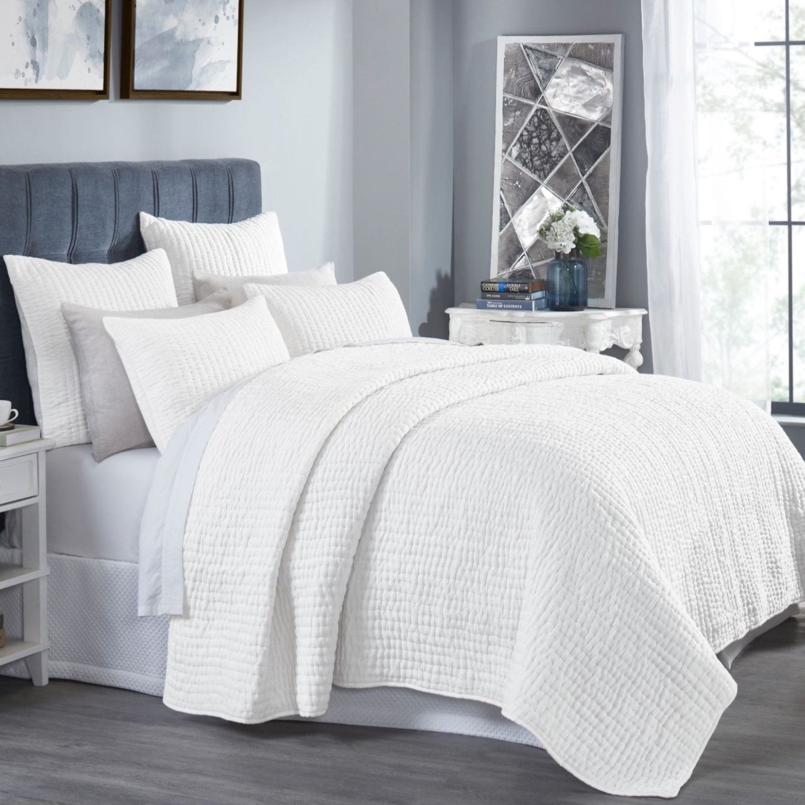 QT-358-9496_2|Crisp white quilted bedding set with subtle textured stripes, draped on a stylish bed creating a serene bedroom environment.