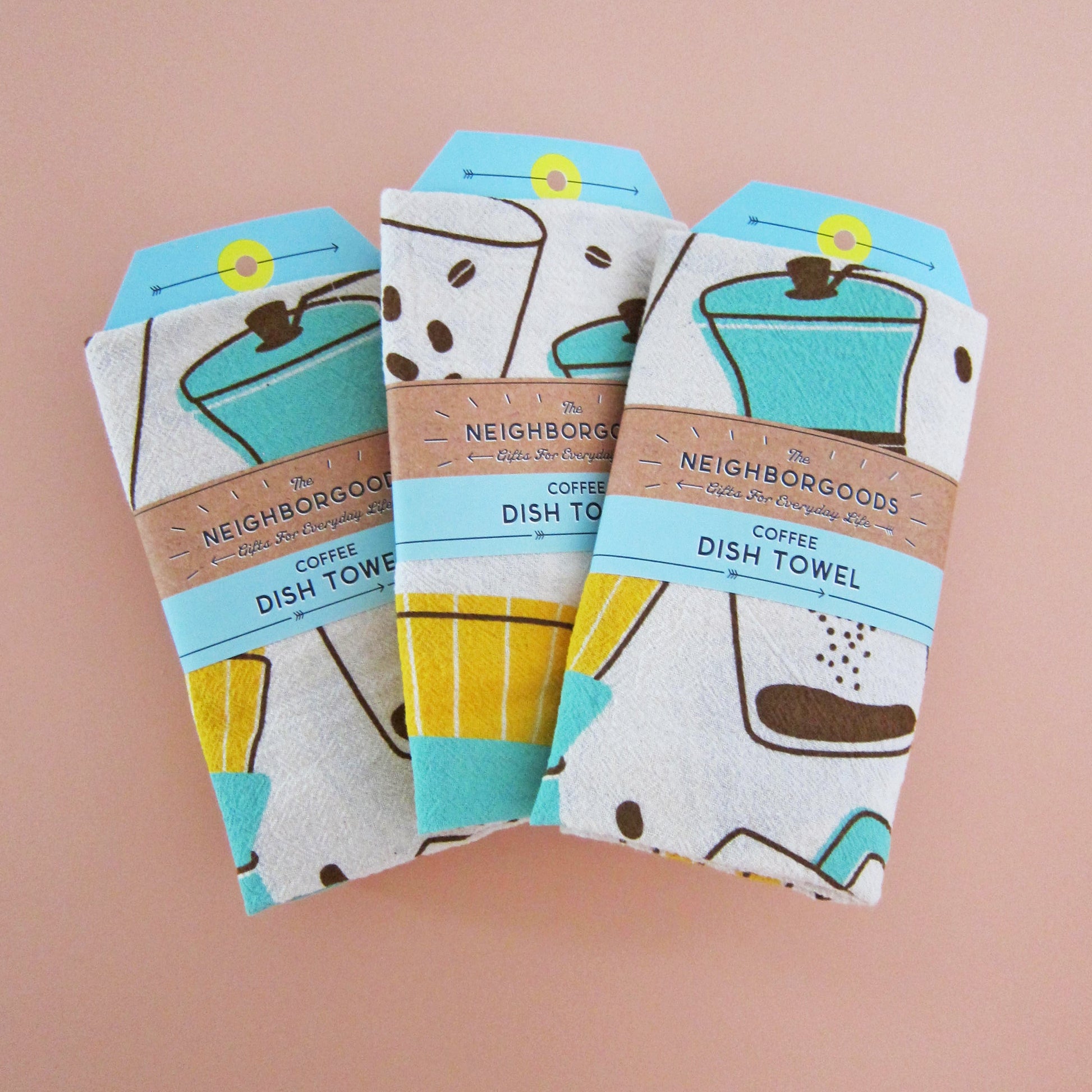 Three coffee dish towels in The Neighborgoods branded belly band sleeve packaging