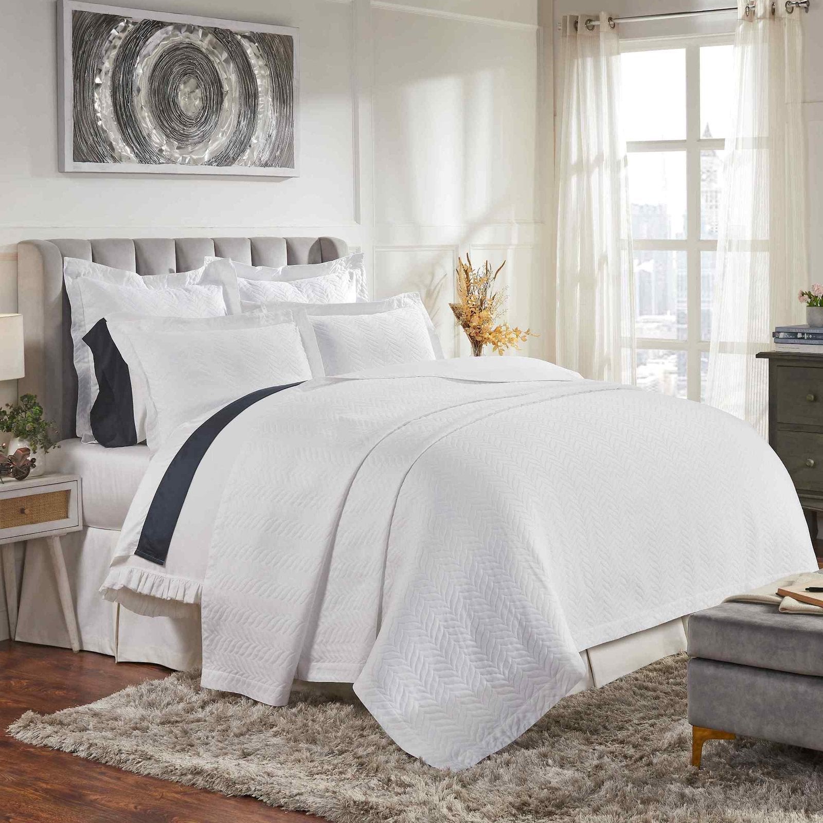 CL-194-9496_1|Stylish white chevron quilted coverlet beautifully draped over a bed, adding a touch of modern luxury and comfort to the decor.