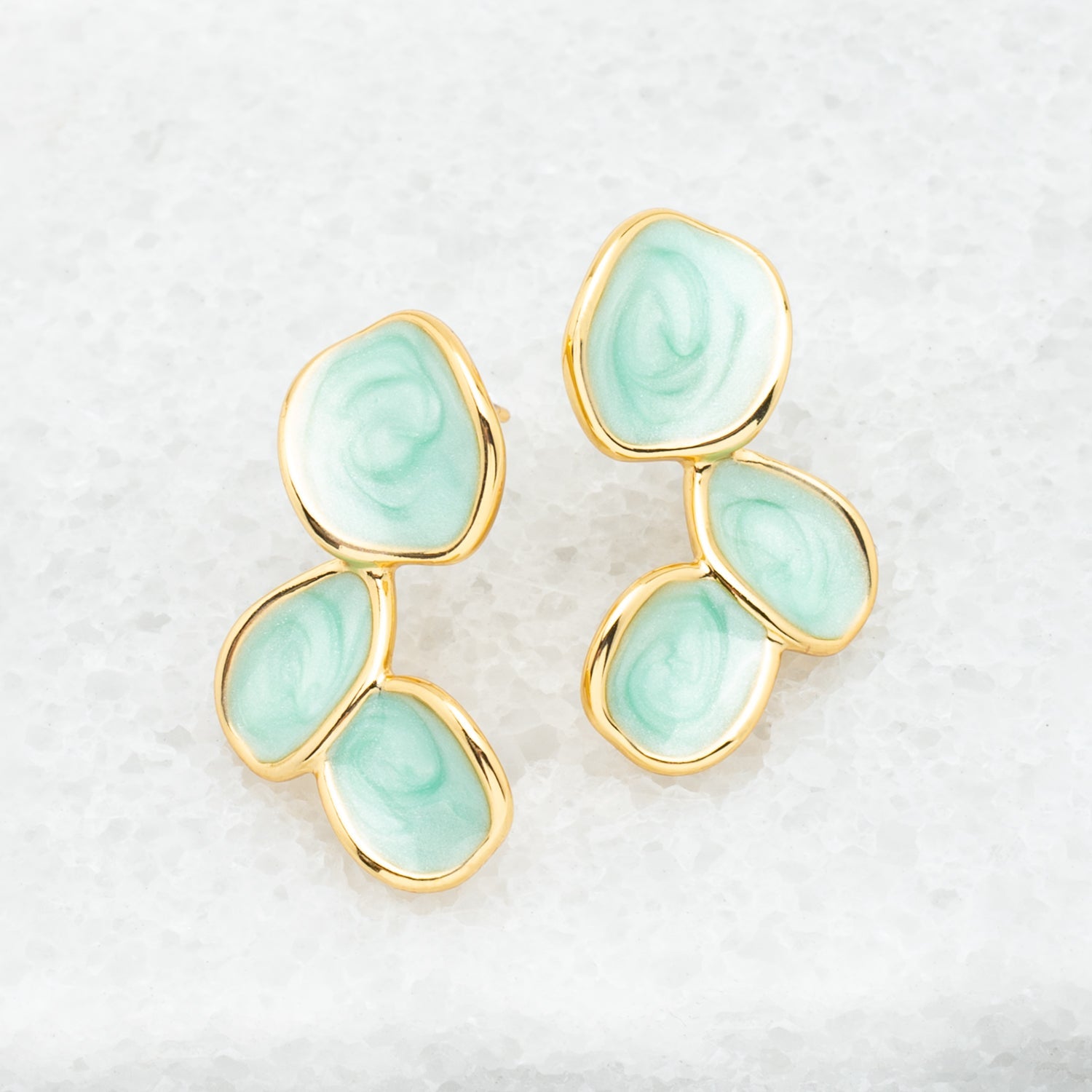 Photo of beautiful earrings, gold-rimmed earrings, shades of green, studs, jewelry business, women's earrings