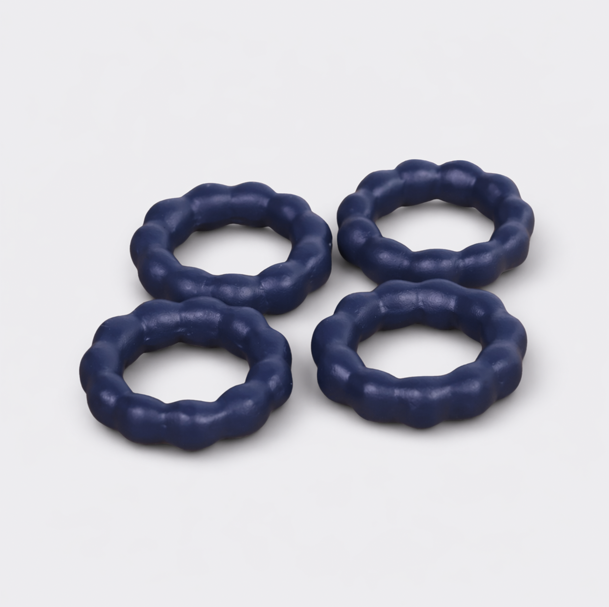  Beaded terracotta napkin rings styled on a festive dining table with cloth napkins
