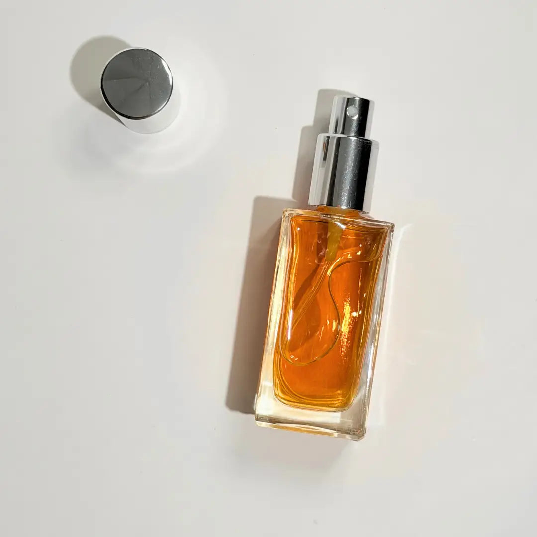 Perfume bottle with a silver cap on a white background