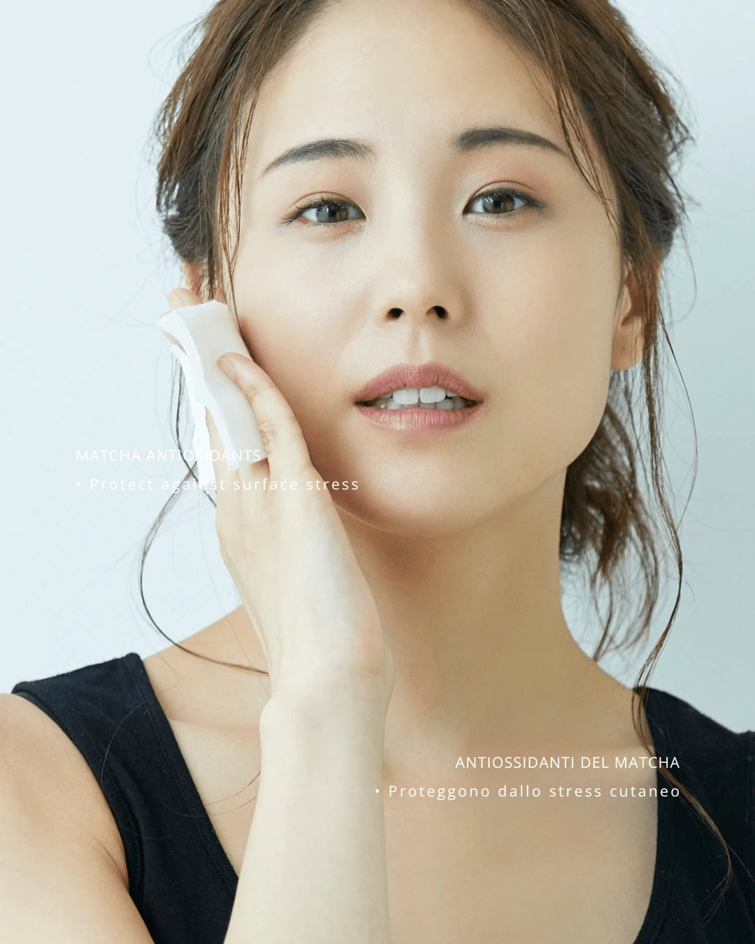 Woman applying a product to her face with a white background