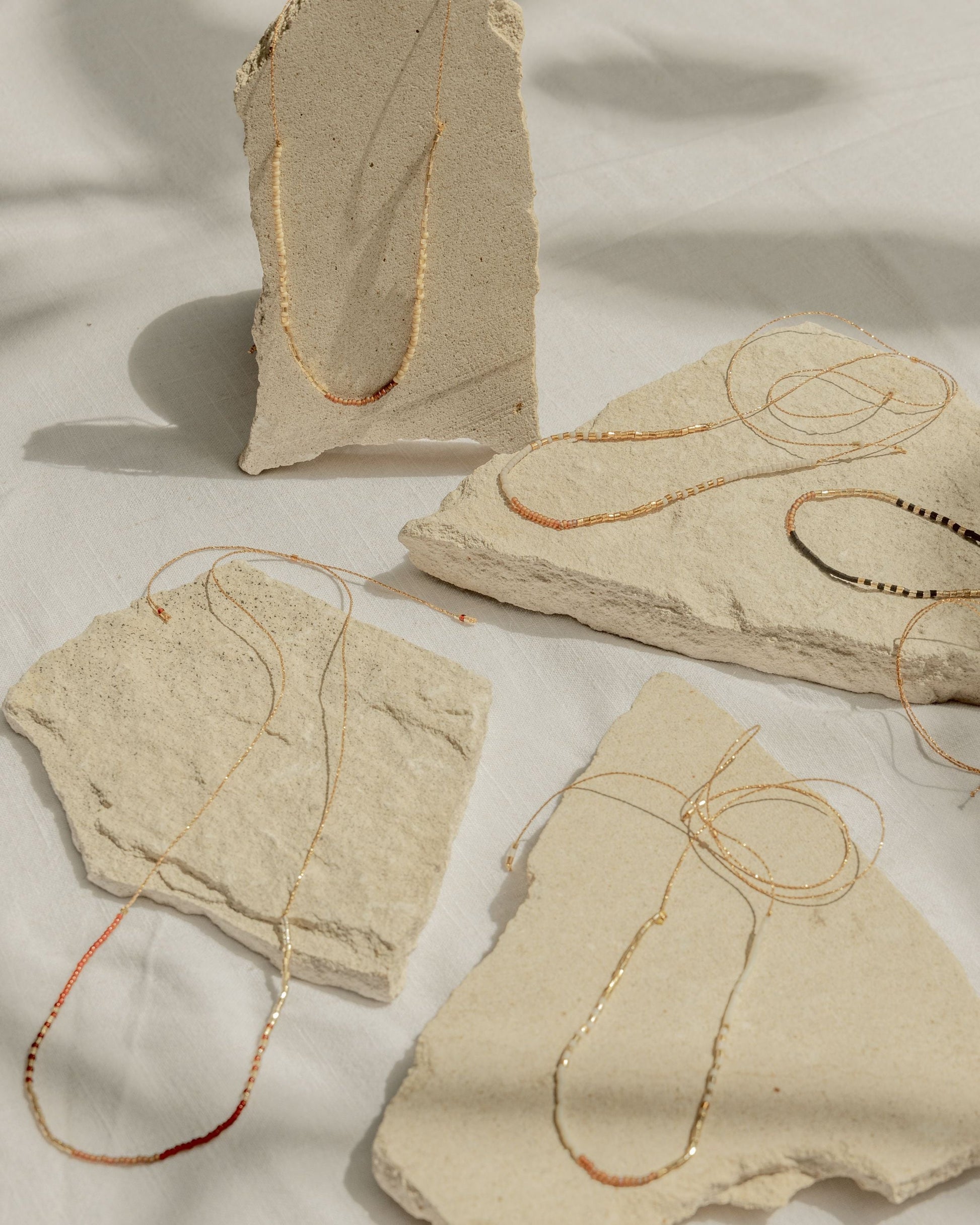 Golden Beaded Necklace handmade by Village Thrive using natural materials.