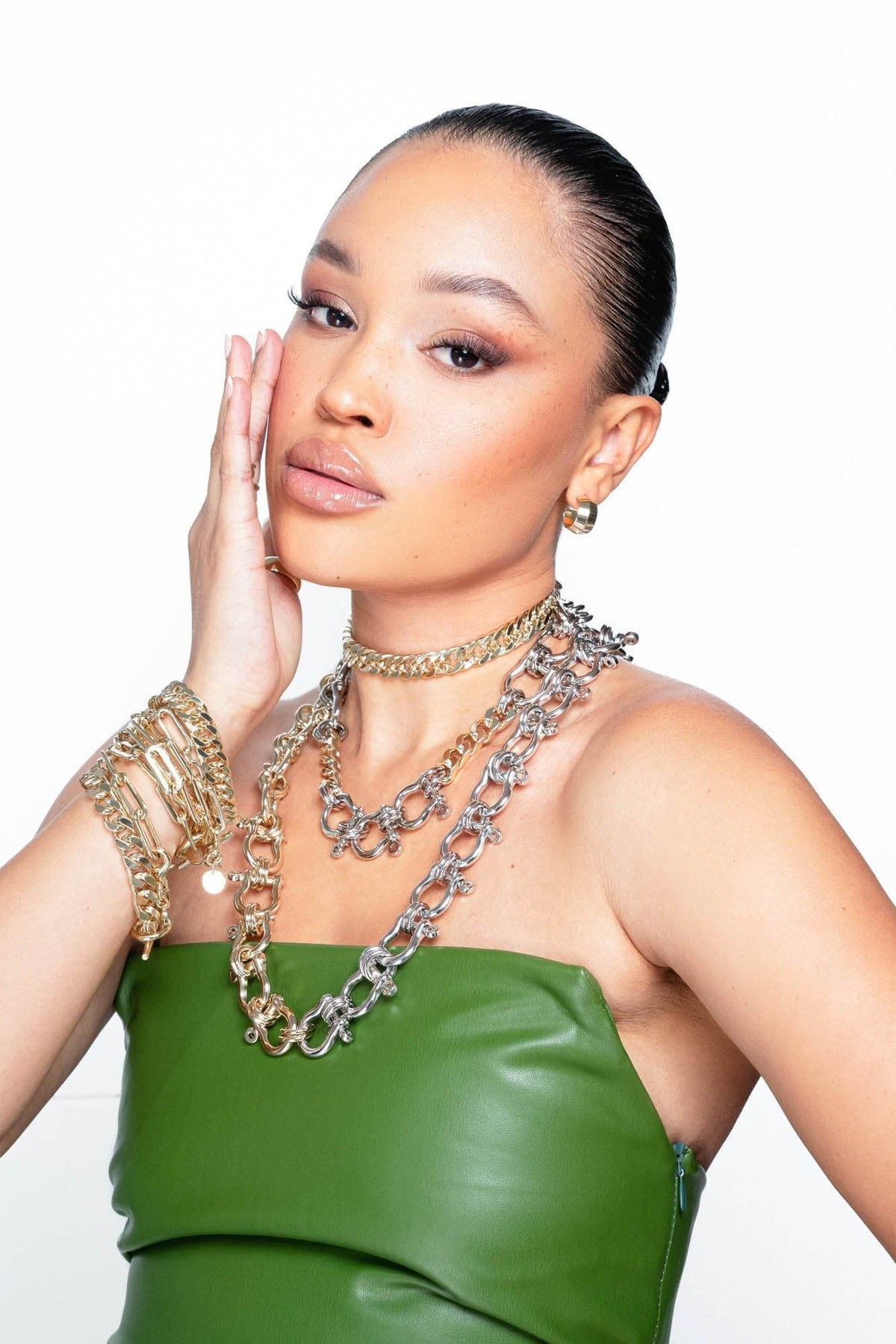Woman showing off Arya Necklace with gold and silver chain jewelry style