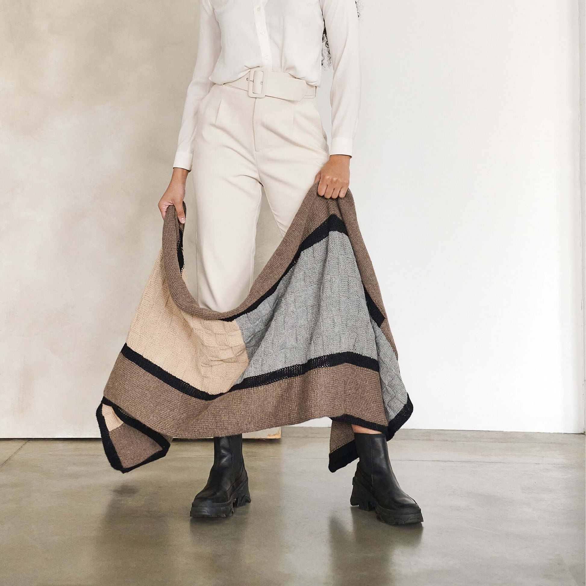 Muhu Brown Gray Hand Knitted Peruvian Alpaca Blanket / Large Plush Scarf displayed by a model in a stylish pose.