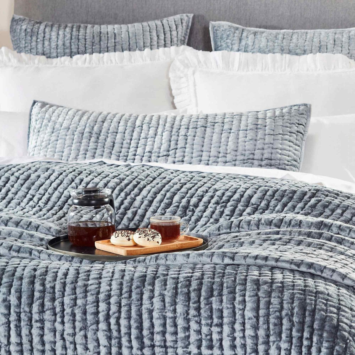 QT-340-X_2|Close-up of dusty blue quilted coverlet on a bed, showing rich ribbed texture. Enhances comfort and modern bedroom appeal.