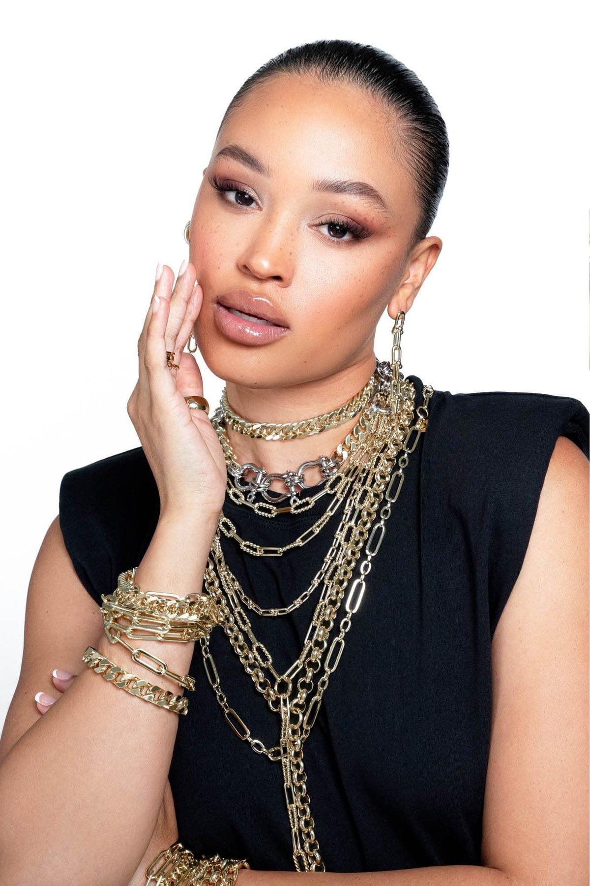 Woman wearing multiple gold chain necklaces and bracelets with Enzo Double Layer Necklace
