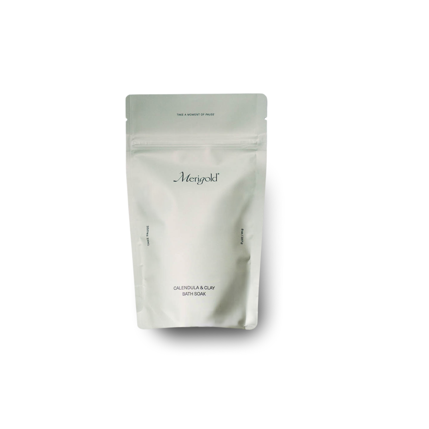 Merigold Calendula & Clay Bath Soak in minimalist faint green resealable bag with subtle branding and clean, modern label design, featuring skin-loving ingredients like calendula petals and French green clay, photographed on white background.