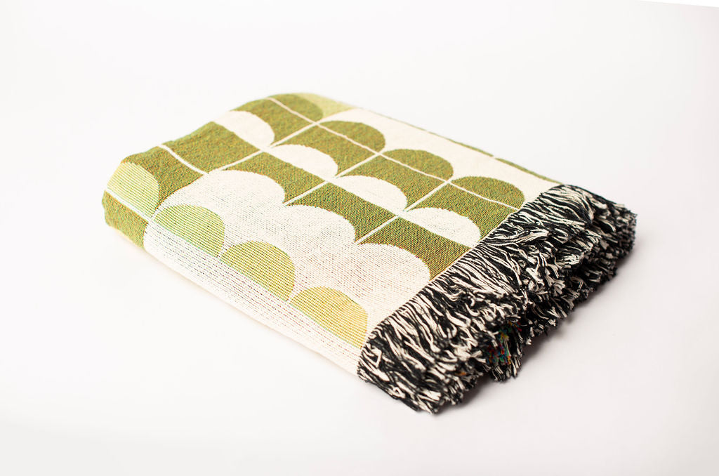 Folded Quinn Meadow geometric woven cotton throw blanket shown from the side