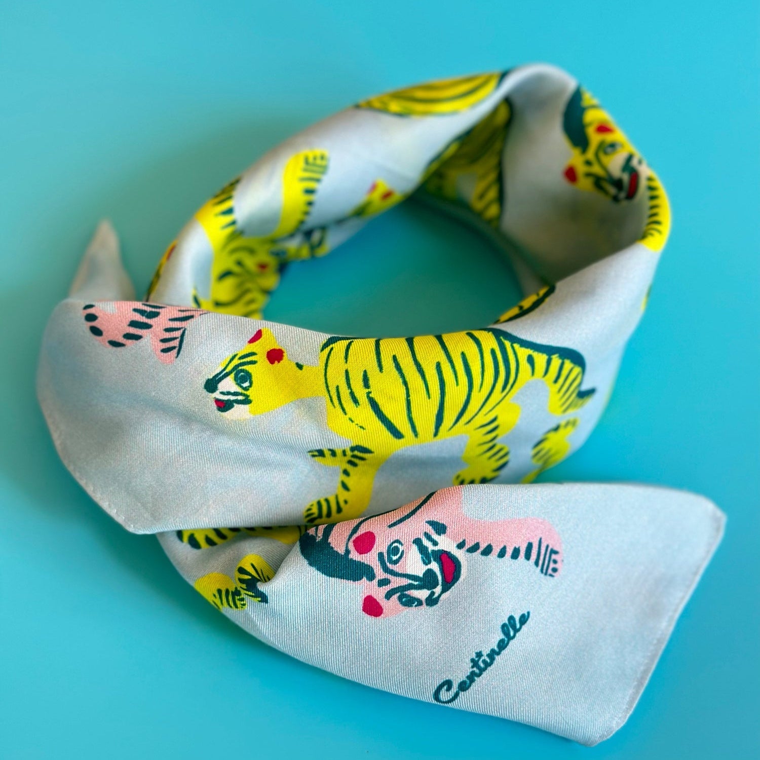 A blue bandana with yellow and green tigers on it.