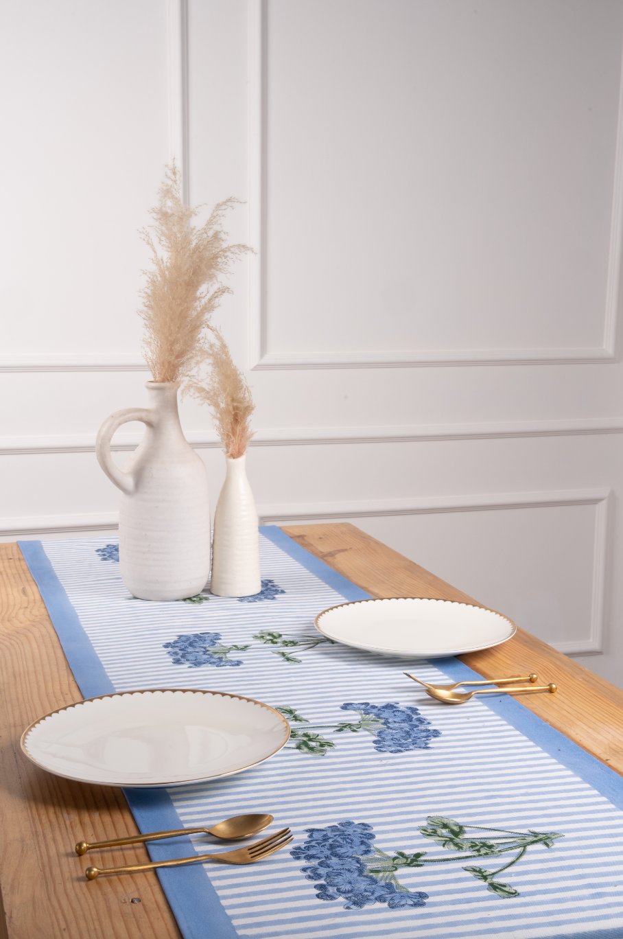 Blue hydrangea striped tablerunner on wooden table with white plates and vases - Inner Child