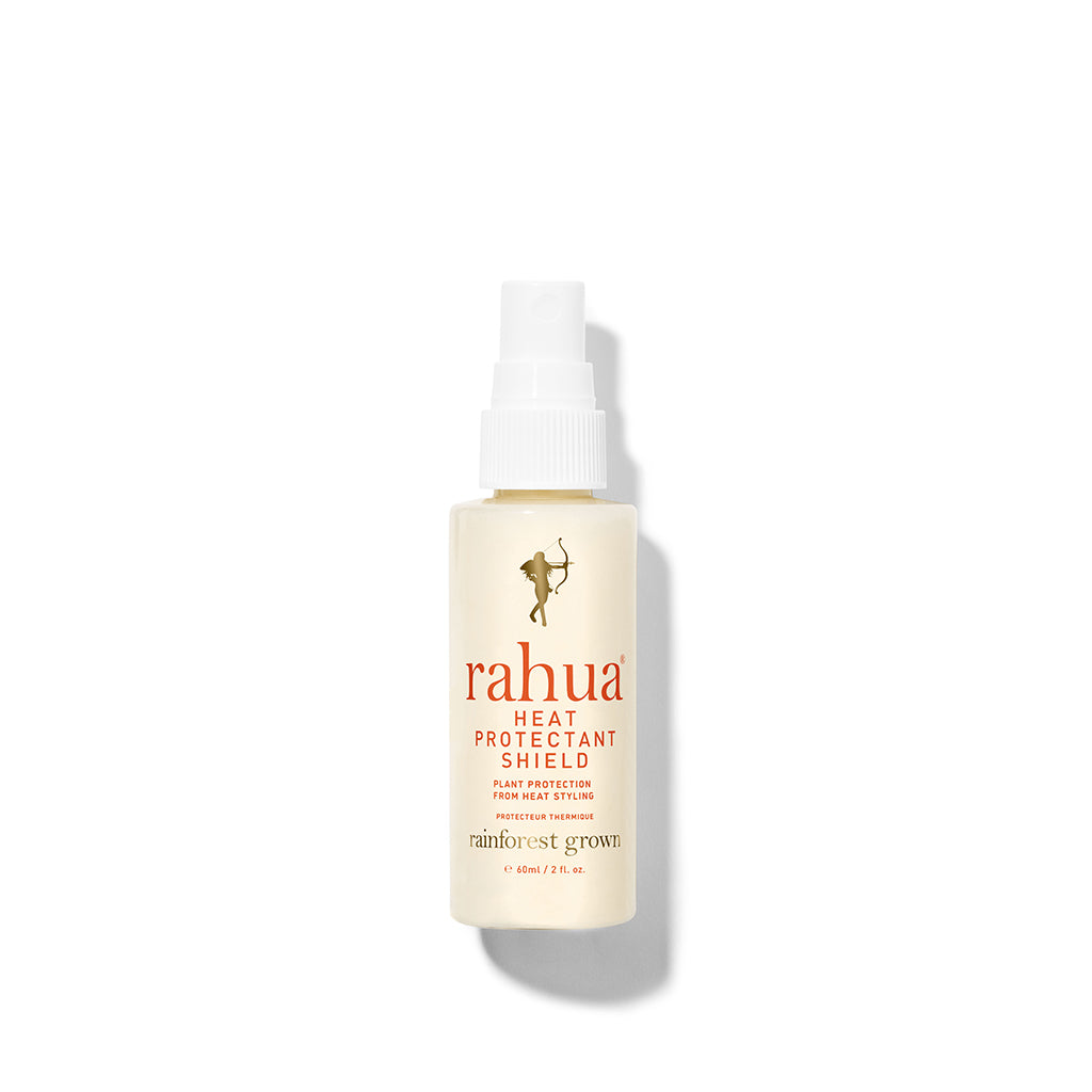 light yellow spray bottle with gold collar with red letter rahua heat protectant shield on a plain white background 2 oz travel friendly tsa safe size|variant:2-oz