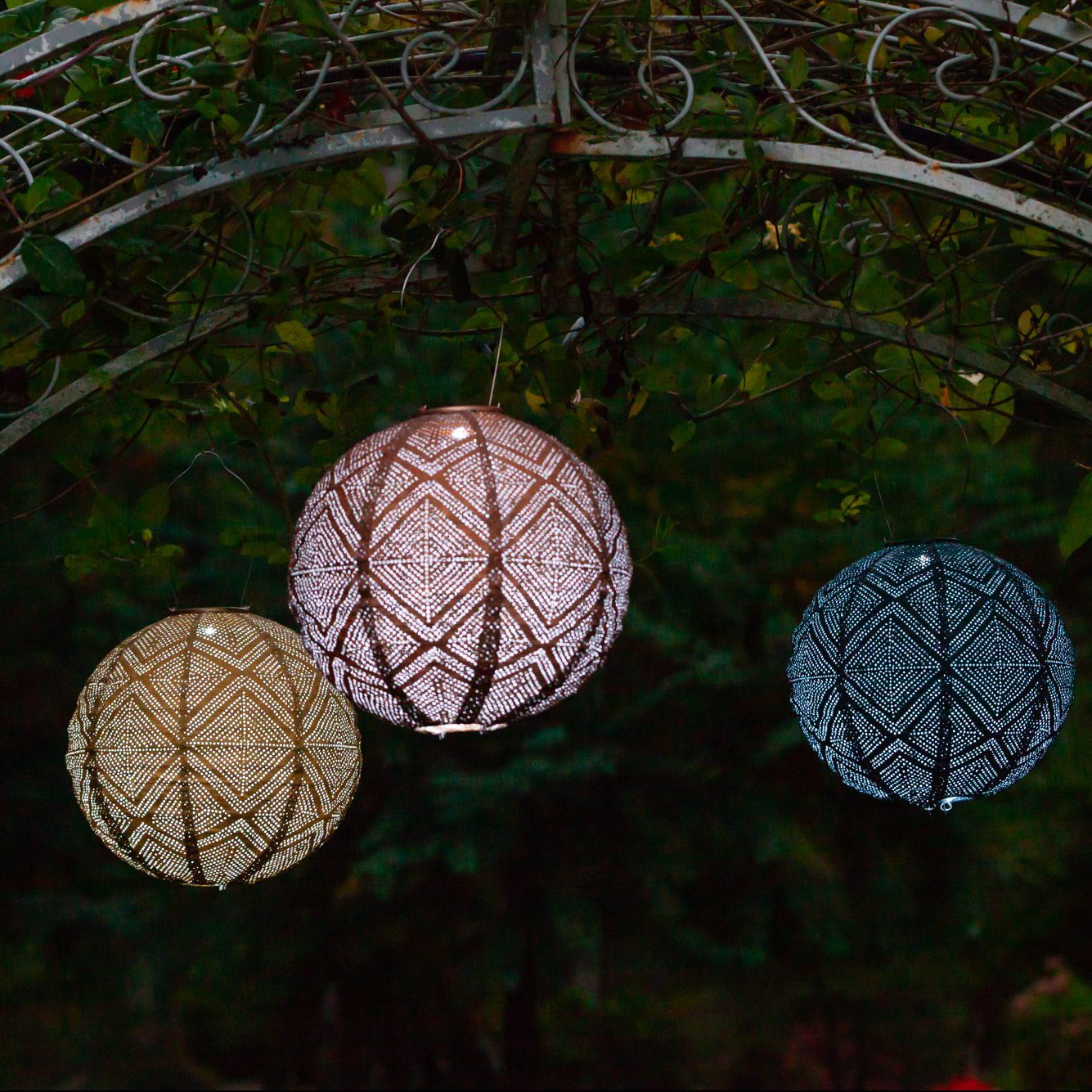 Soji Stella Market 12" Tyvek Solar Lanterns hanging from arbor