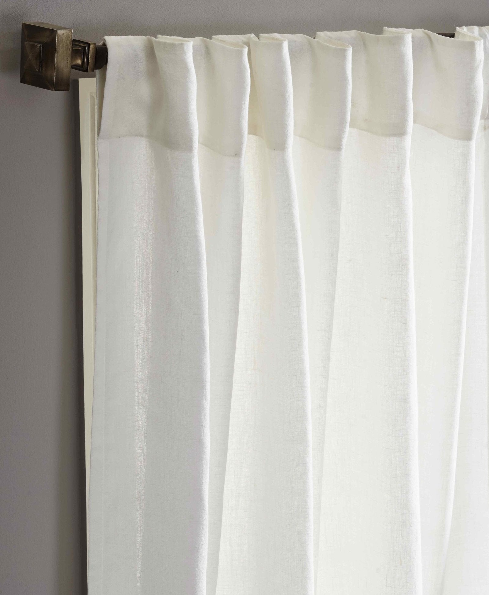 DY-712-X_2|Close-up of elegant white linen curtains on a dark curtain rod. Provides light filtering for living spaces.