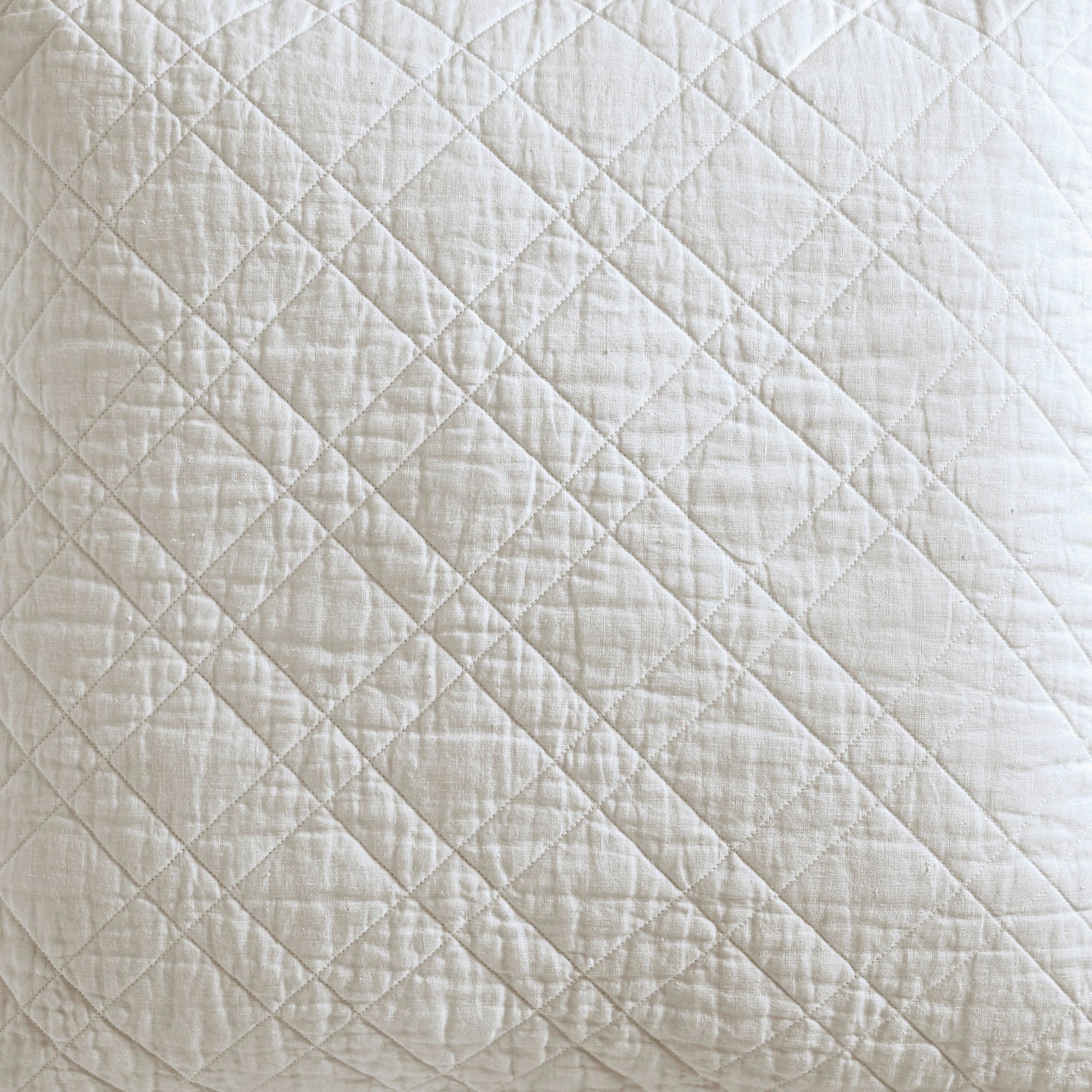 SS-254-2026_3|Close-up of warm oatmeal diagonal diamond-quilted coverlet fabric, providing cozy texture and natural appeal for bedroom.