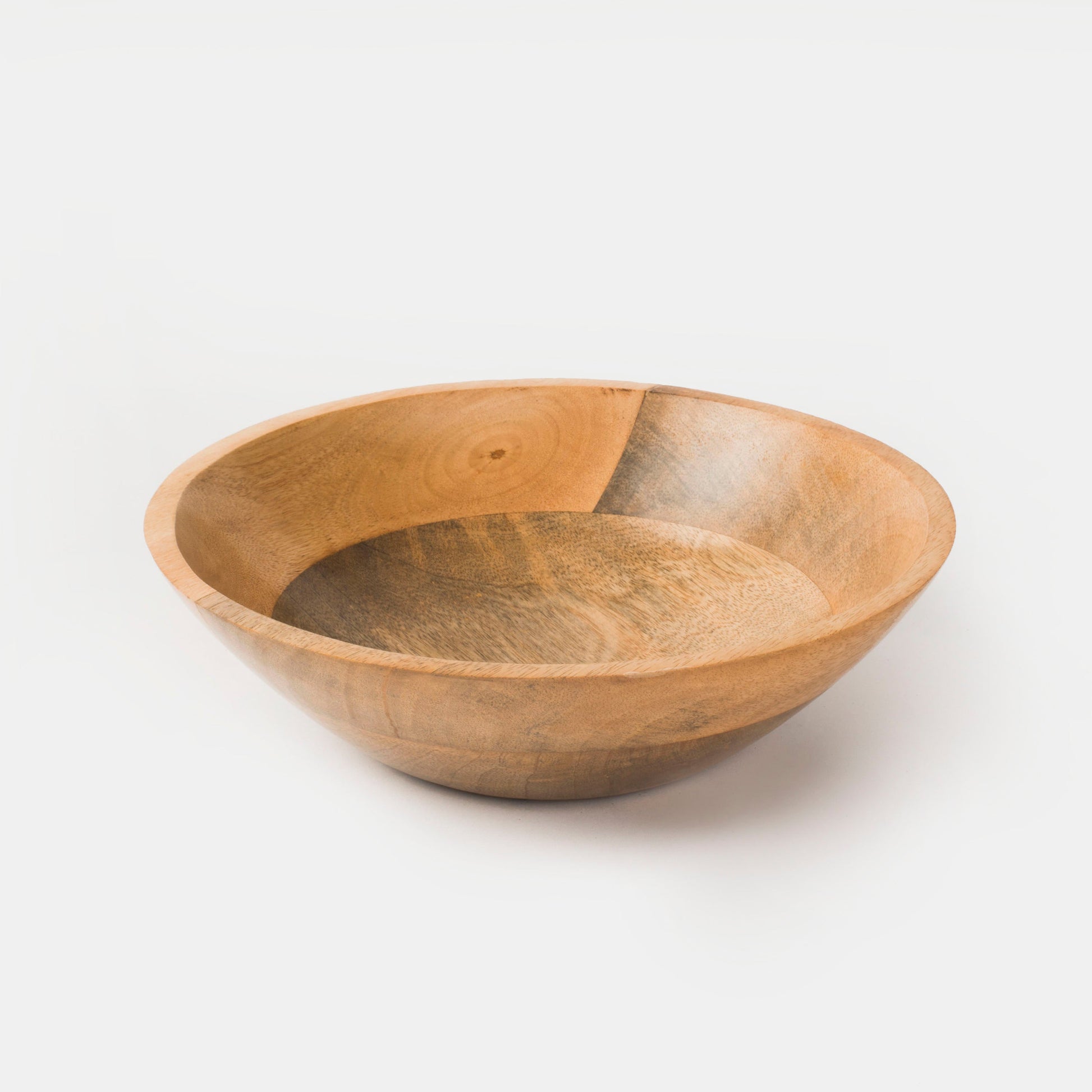 Close-up of the sealed natural finish on a solid mango wood bowl highlighting unique grain variations.
