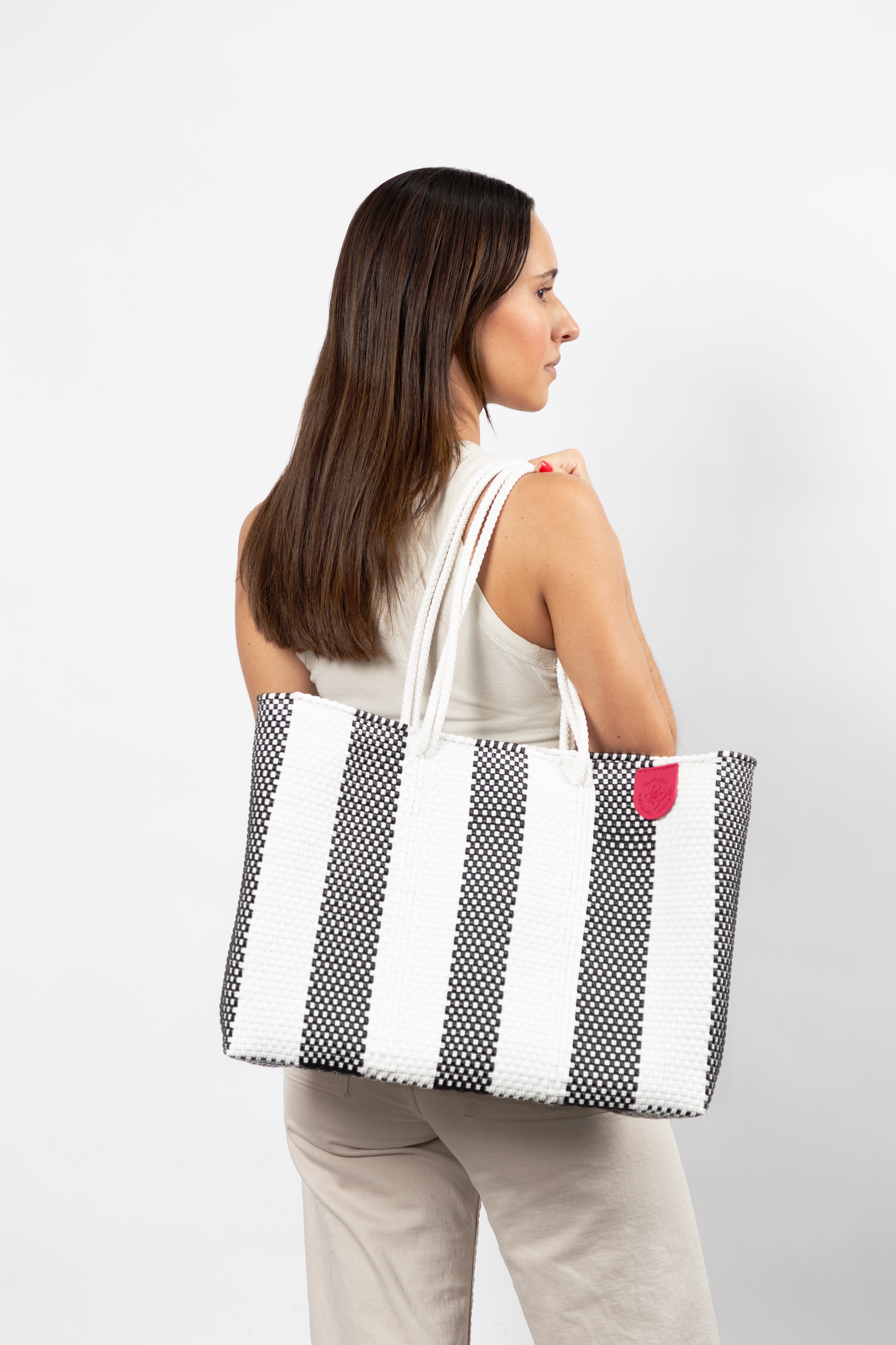 Tin Marin super tote in Zebra Design, A model carrying Tin Marin woven super tote in black and white