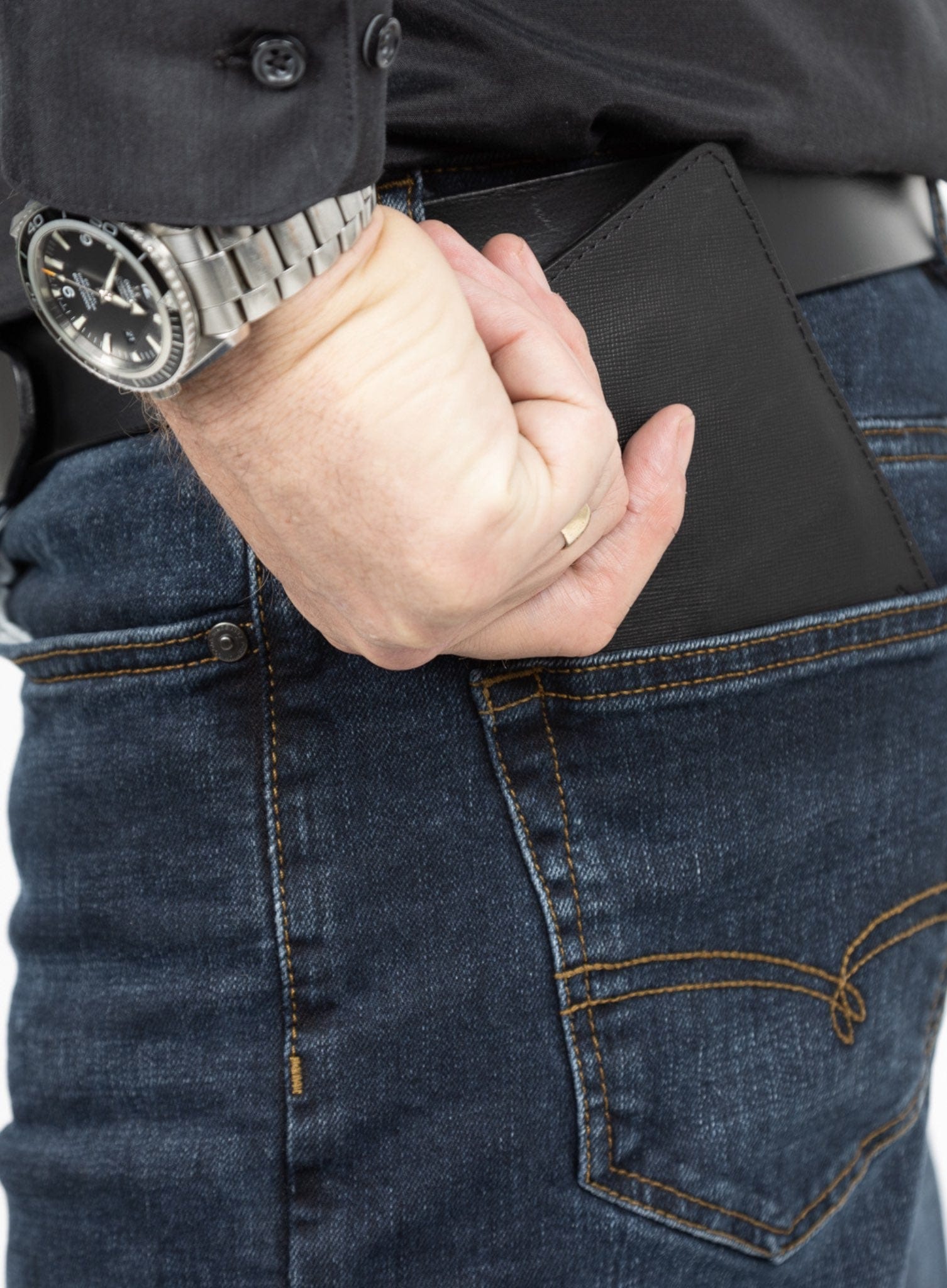 operators passport cover in black showcasing model putting it in pocket.