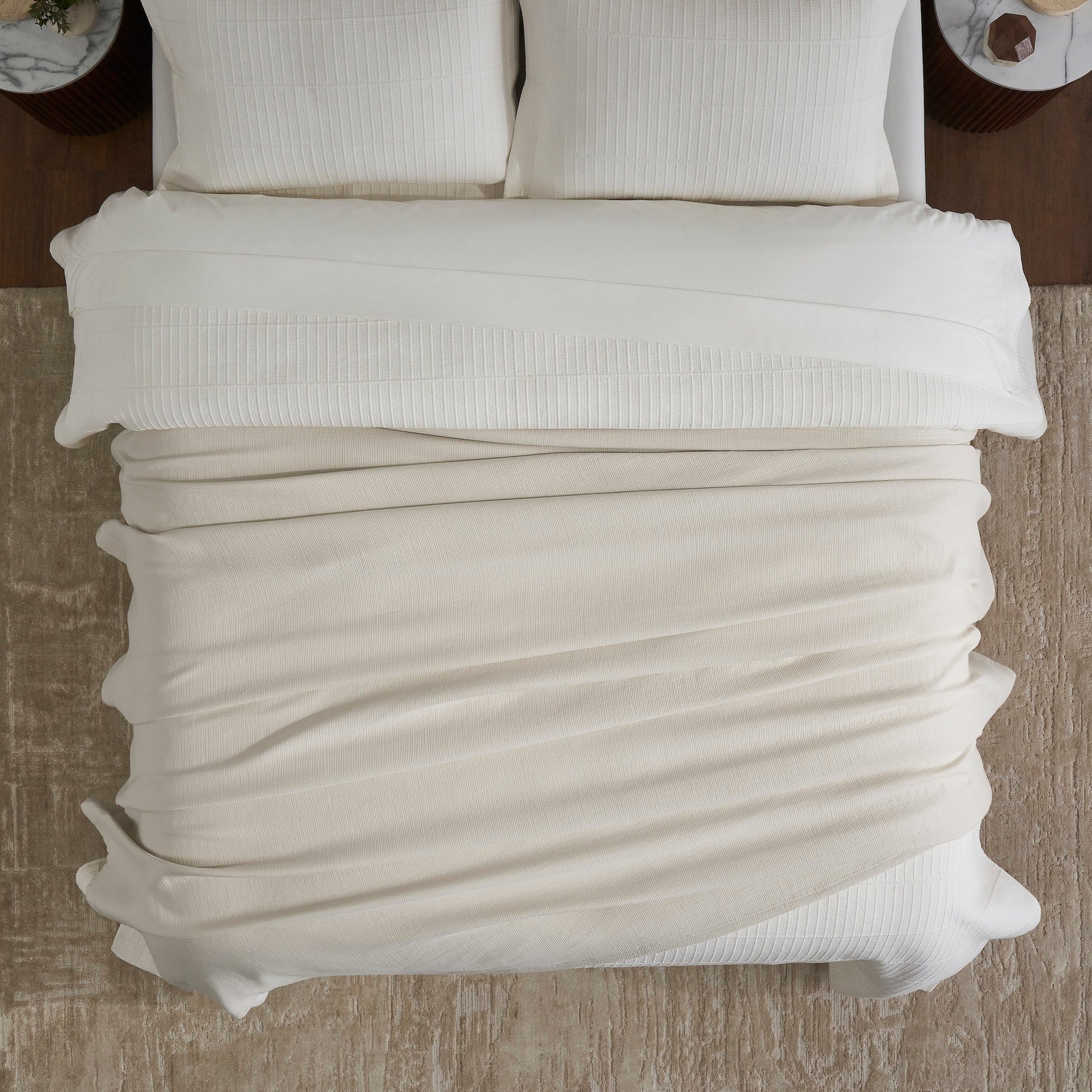 BL-860-11096_4|Overhead view of a cozy cream waffle weave blanket on a bed, perfect for warm, inviting bedroom decor. Soft, textured.