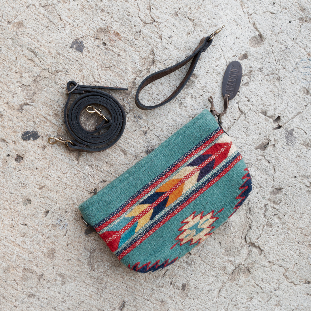 Handwoven convertible clutch with Zapotec pattern in bold colors; can be used as a pouch, wristlet, or crossbody with included leather straps and internal pocket.