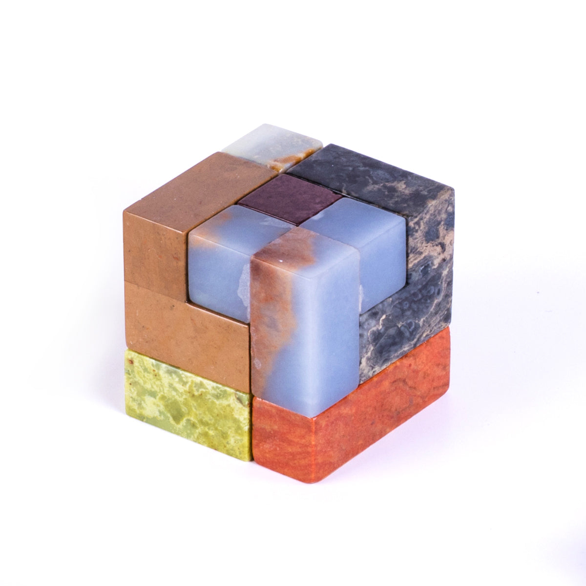 Fully assembled gemstone Soma cube puzzle showcasing the precision of its 3D interlocking stone blocks on a pristine white background.