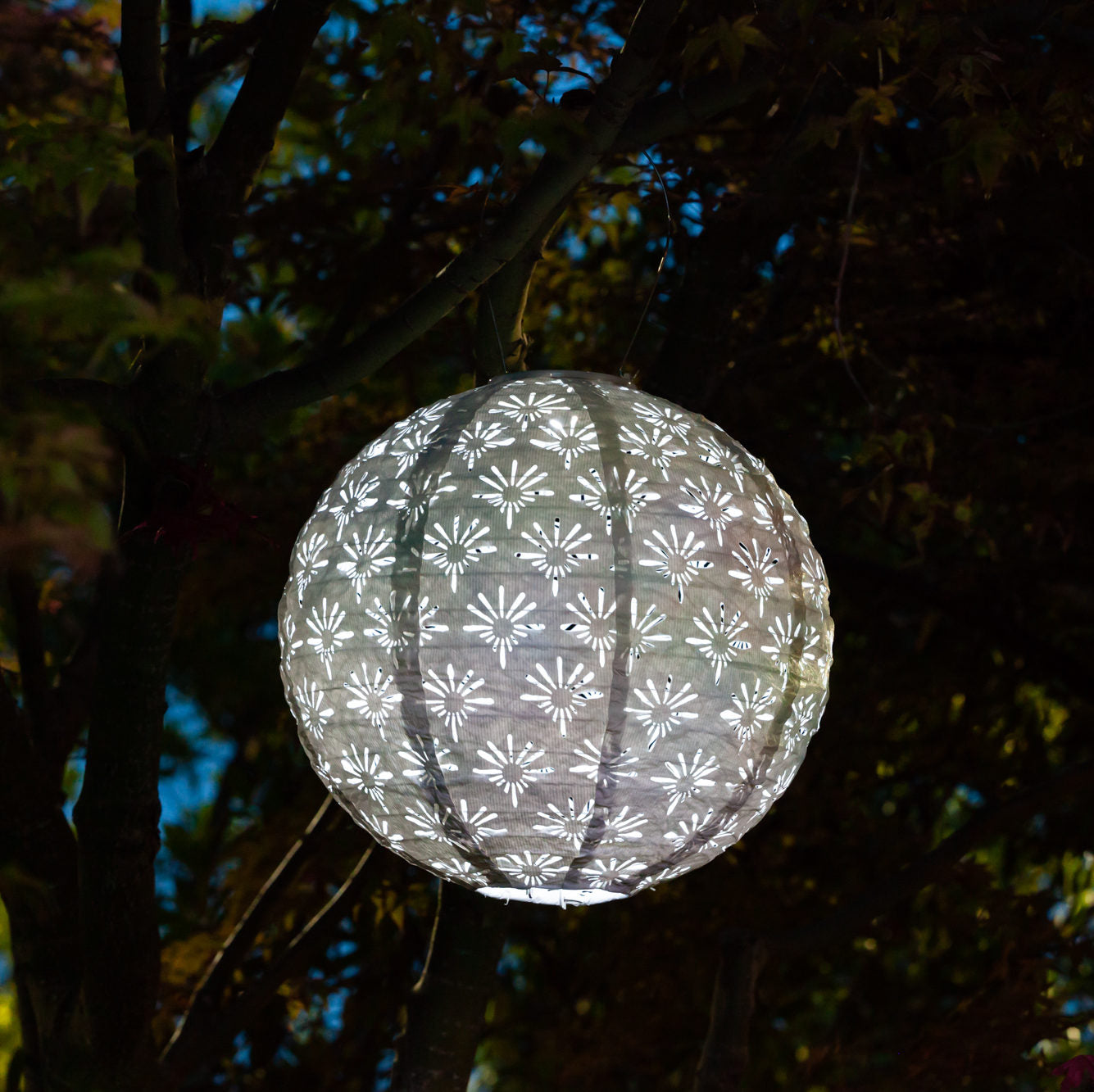Soji Stella Deco Globe Tyvek Solar Lantern glowing at night