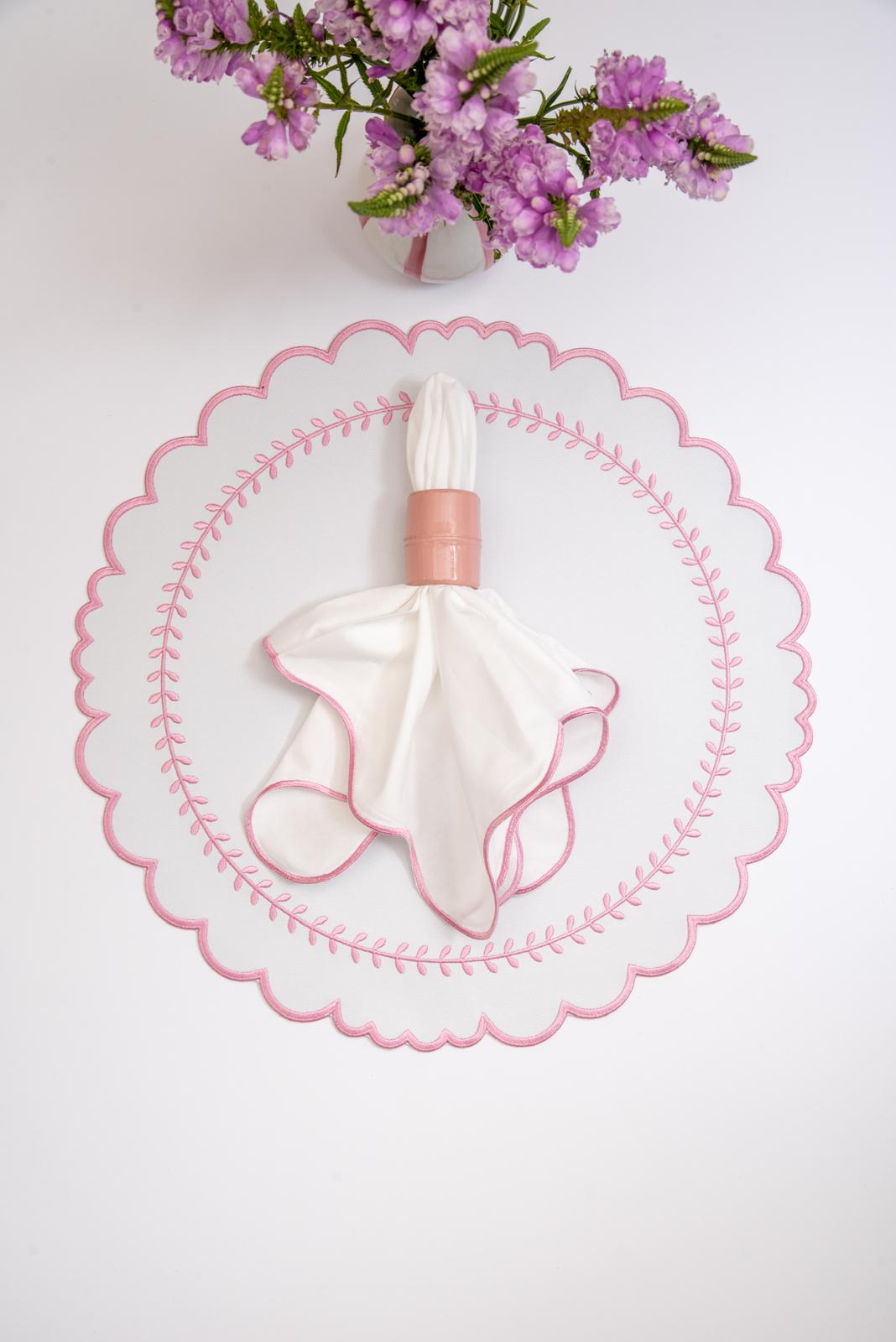 Arrow impermeable placemat with geometric border design in pink by Talah Home