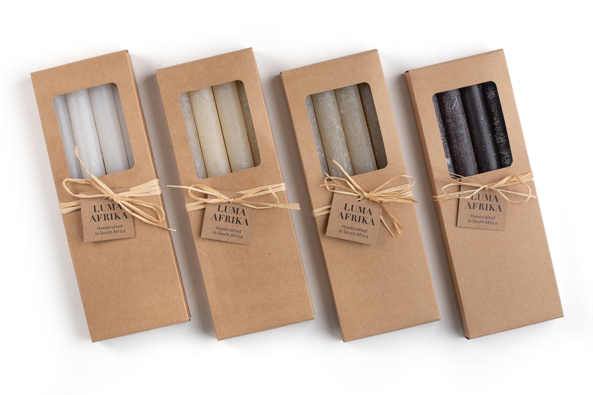 Luma Africa frosted candles, handmade in Africa.  4 taper boxes in Frost White, Cream, Sand & Black. Beautiful yet simple gift presentation in brown kraft box with story card.