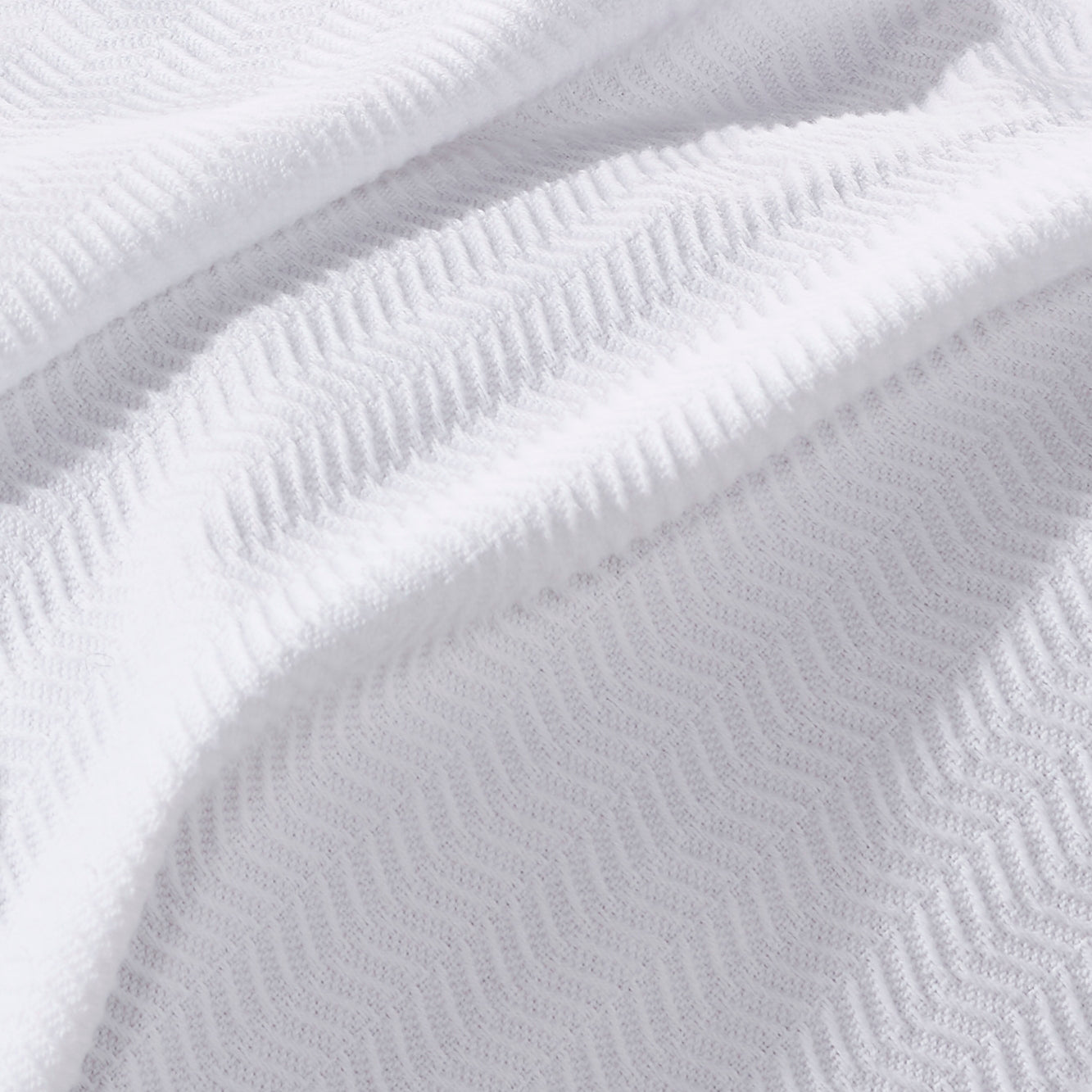 BL-853-11096_4|Detailed close-up of a soft white textured blanket, showcasing its intricate woven pattern and cozy, inviting fabric.