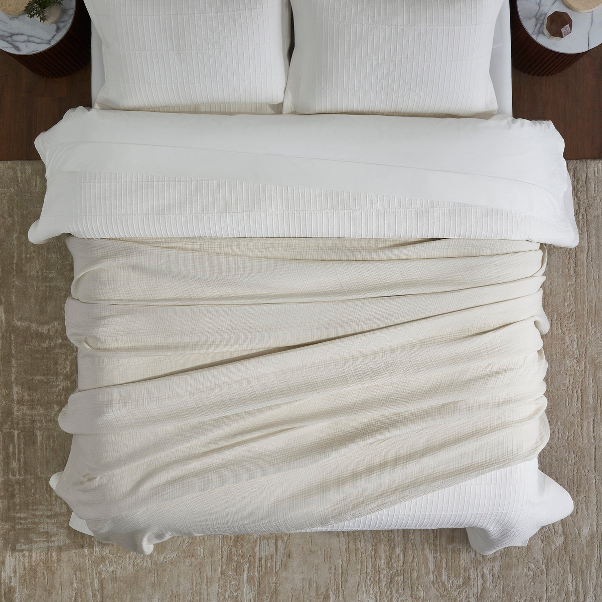 BL-862-11096_4|Cream textured cotton blanket casually draped across a bed, offering an inviting, soft layer and stylish neutral bedding decor.