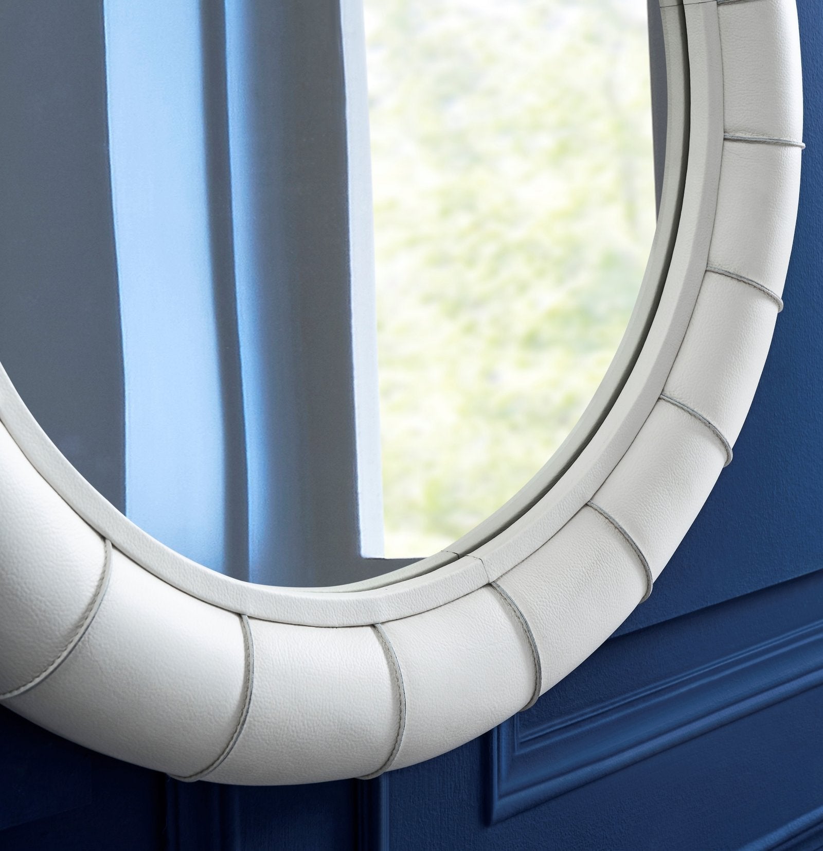 FN-5203-33233_4|Close-up of luxurious white padded leather mirror frame with intricate stitching details. Elegant wall decor.