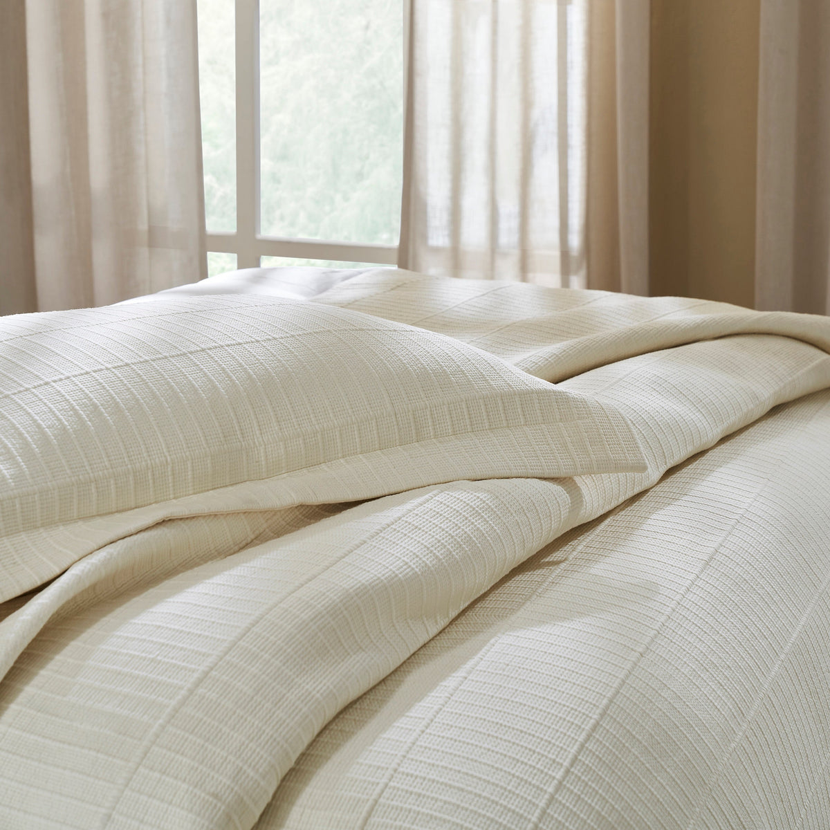 CL-271-9496_7|Luxurious cream textured coverlet and pillow shams on bed. Features subtle striped pattern, elegant and cozy bedroom bedding.