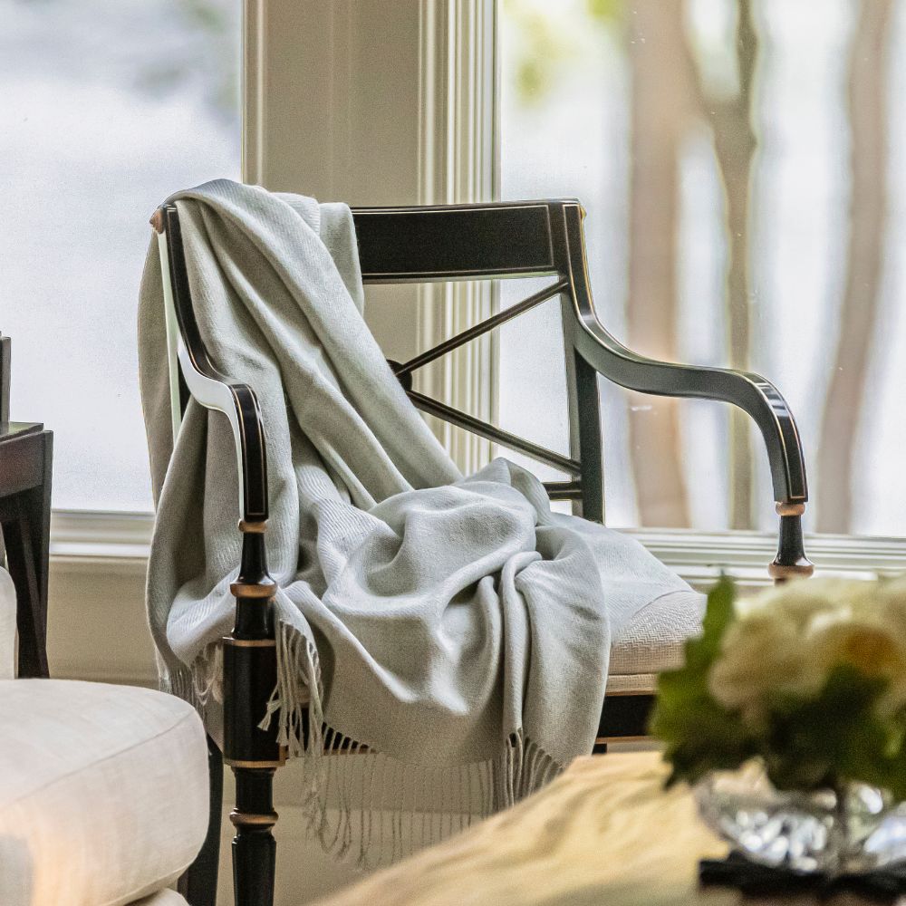 Grey artisanal woven throw on chair