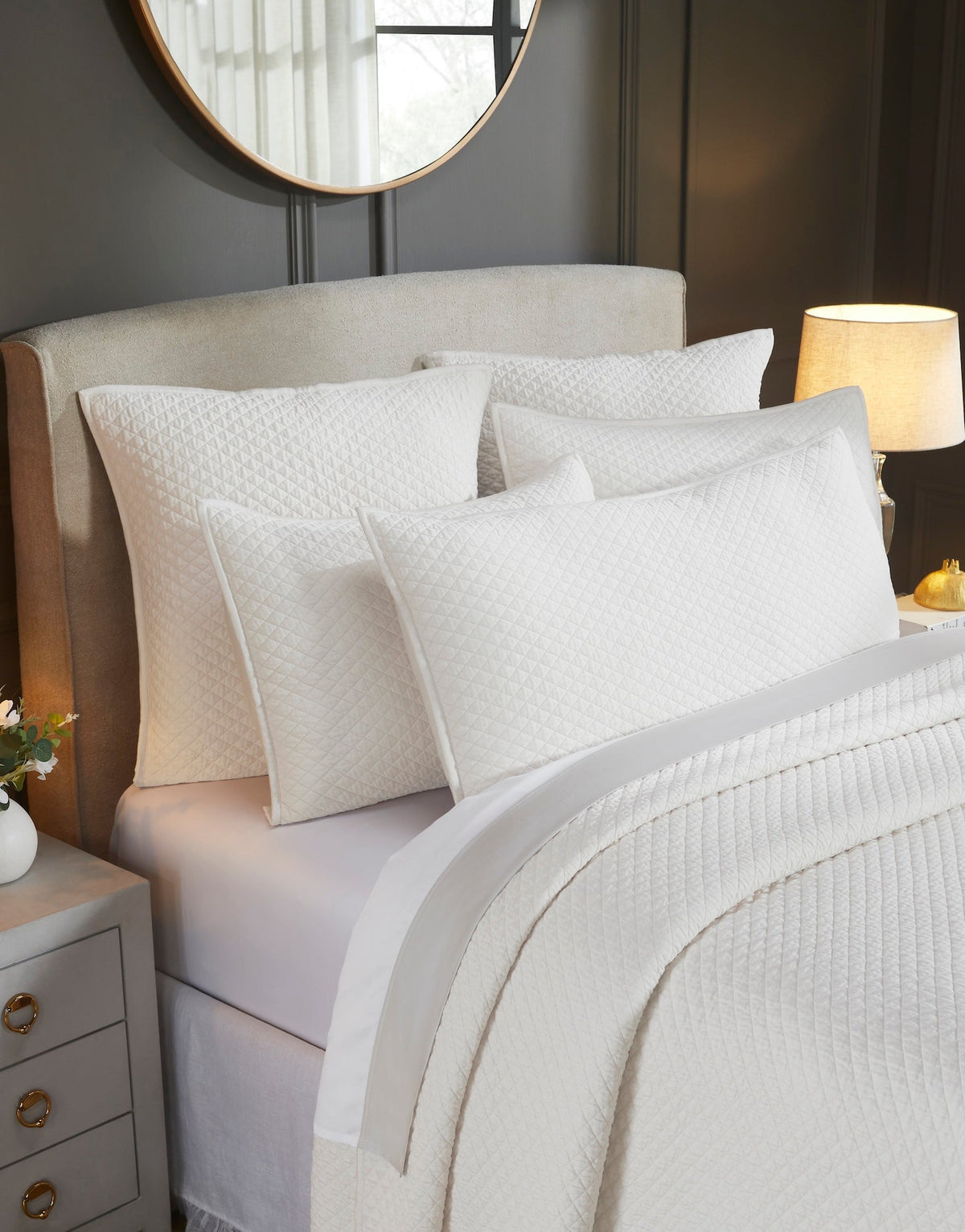 CL-265-9496_3|Close-up of white diamond quilted coverlet and matching pillows, showcasing intricate patterns. Luxurious, soft bedding ensemble.