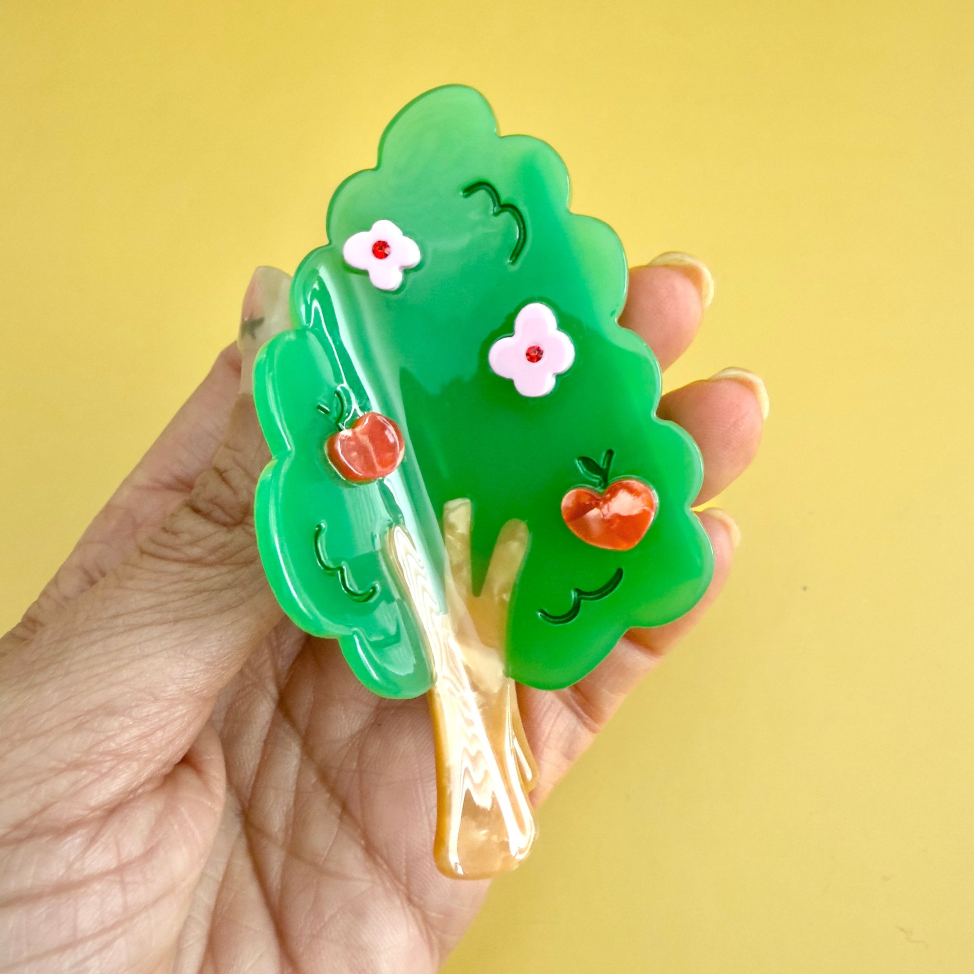 Hair claw shaped like a tree with green leaves, red apples, and pink flowers 