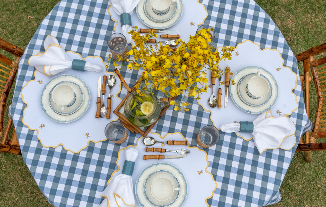 Bumble bee impermeable placemat with hand-stitched bee embroidery and yellow wavy border by Talah Home