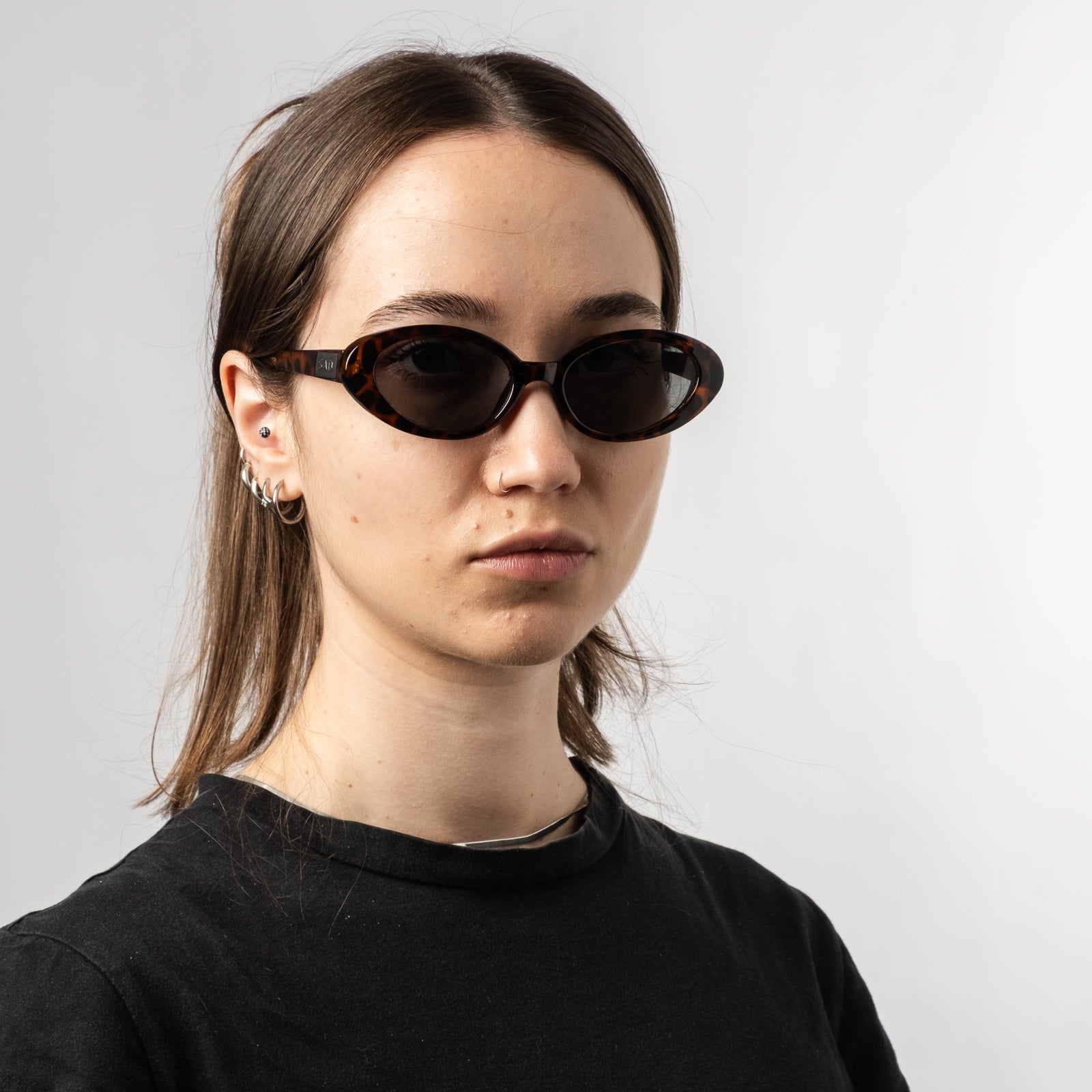 Female wearing Sad Eyewear Bloom oval sunglasses in tortoise with UV protection lenses