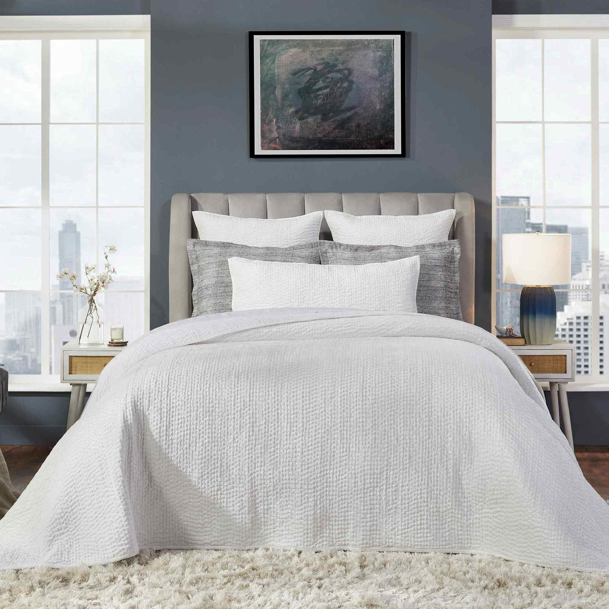 CL-195-11096_4|Detailed view of a navy blue textured quilted coverlet on a bed, showcasing its soft plush fabric and contemporary design.