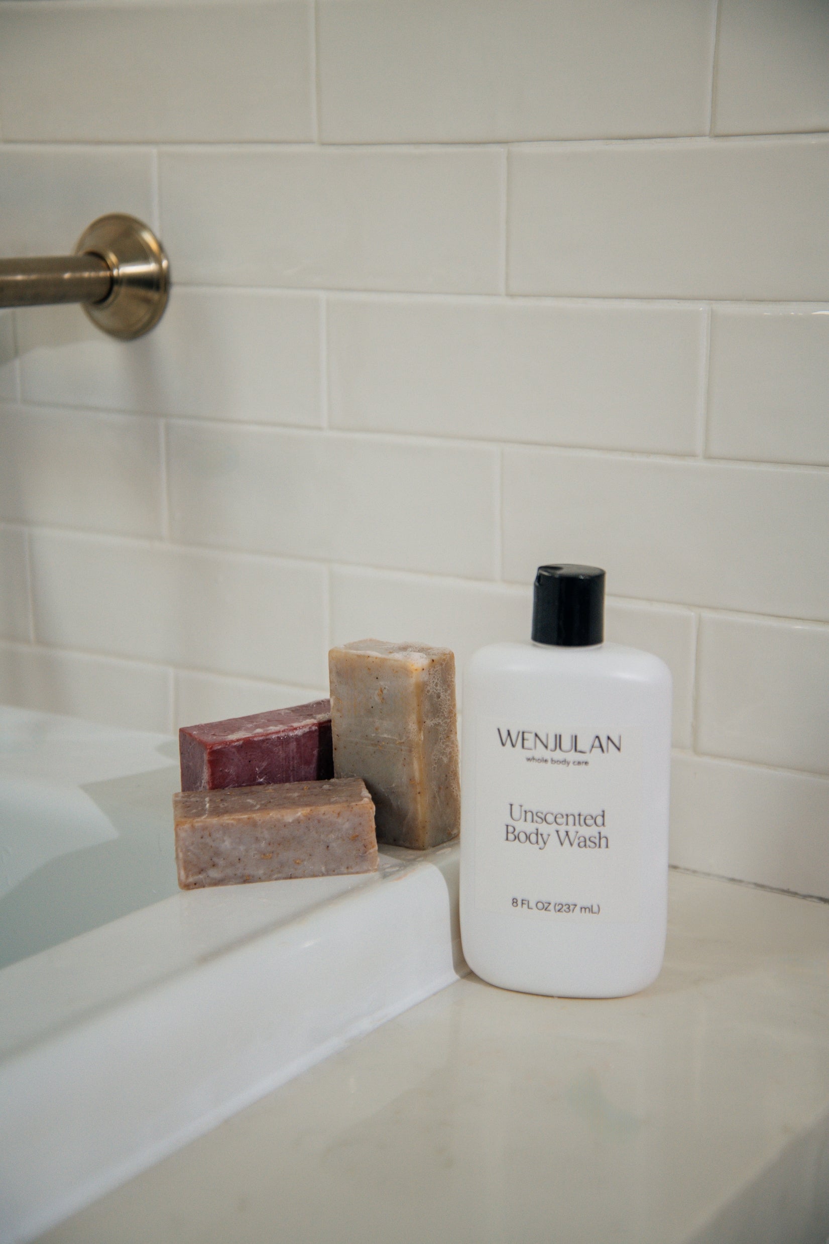 Wenjulan Whole Body Care Complete Care Collection bundle gift pack featuring Wenjulan Unscented Cleansing Soap with Colloidal Oatmeal bar, Wenjulan Sensitive Skin Cleansing Soap with Kaolin Clay bar, Wenjulan Southwest Cedar Cleansing Soap bar, Wenjulan Unscented Body Wash liquid soap in a bathroom setting