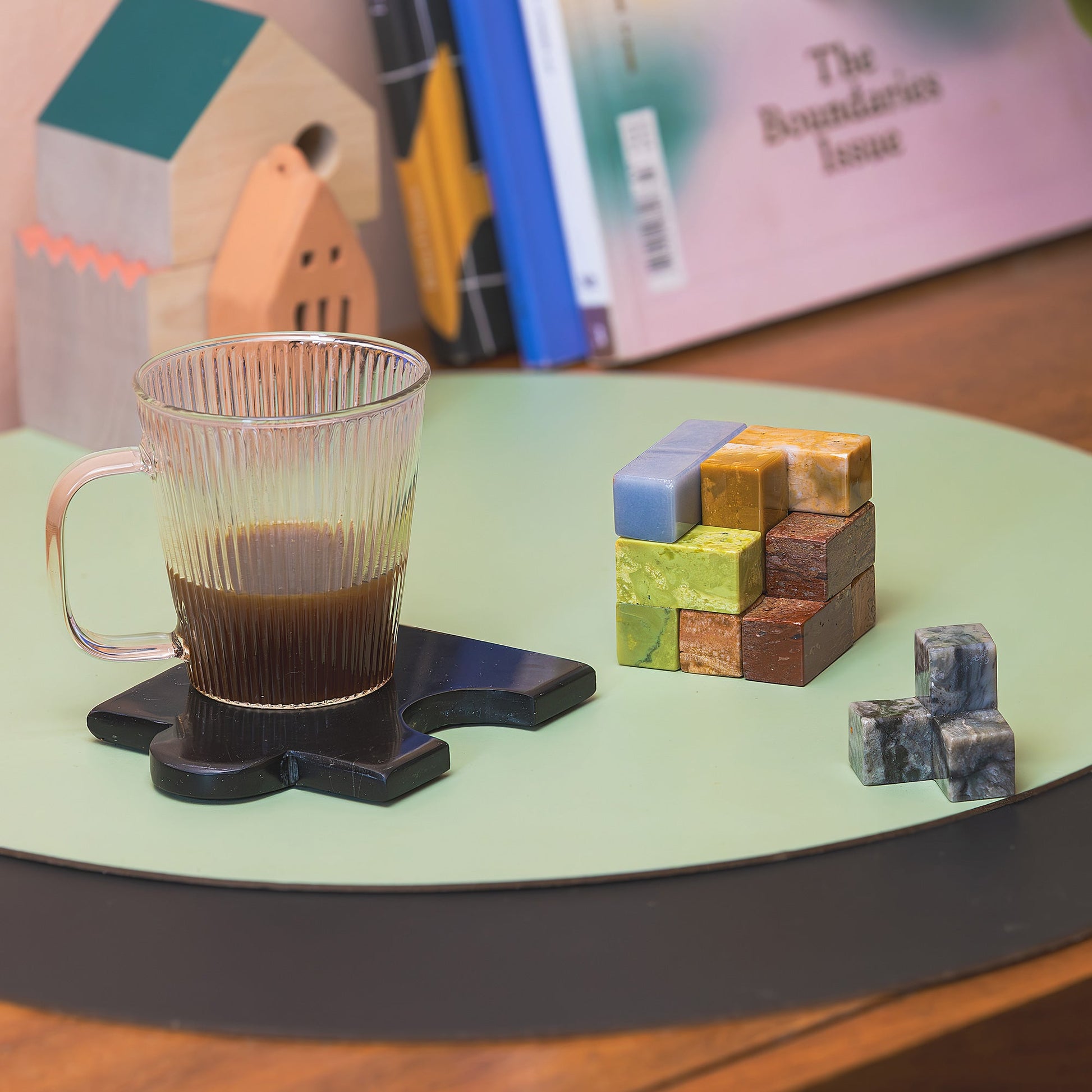 The heavy mineral Soma cube puzzle displayed elegantly on a contemporary shelf, blending functional gameplay with high-end interior aesthetics.