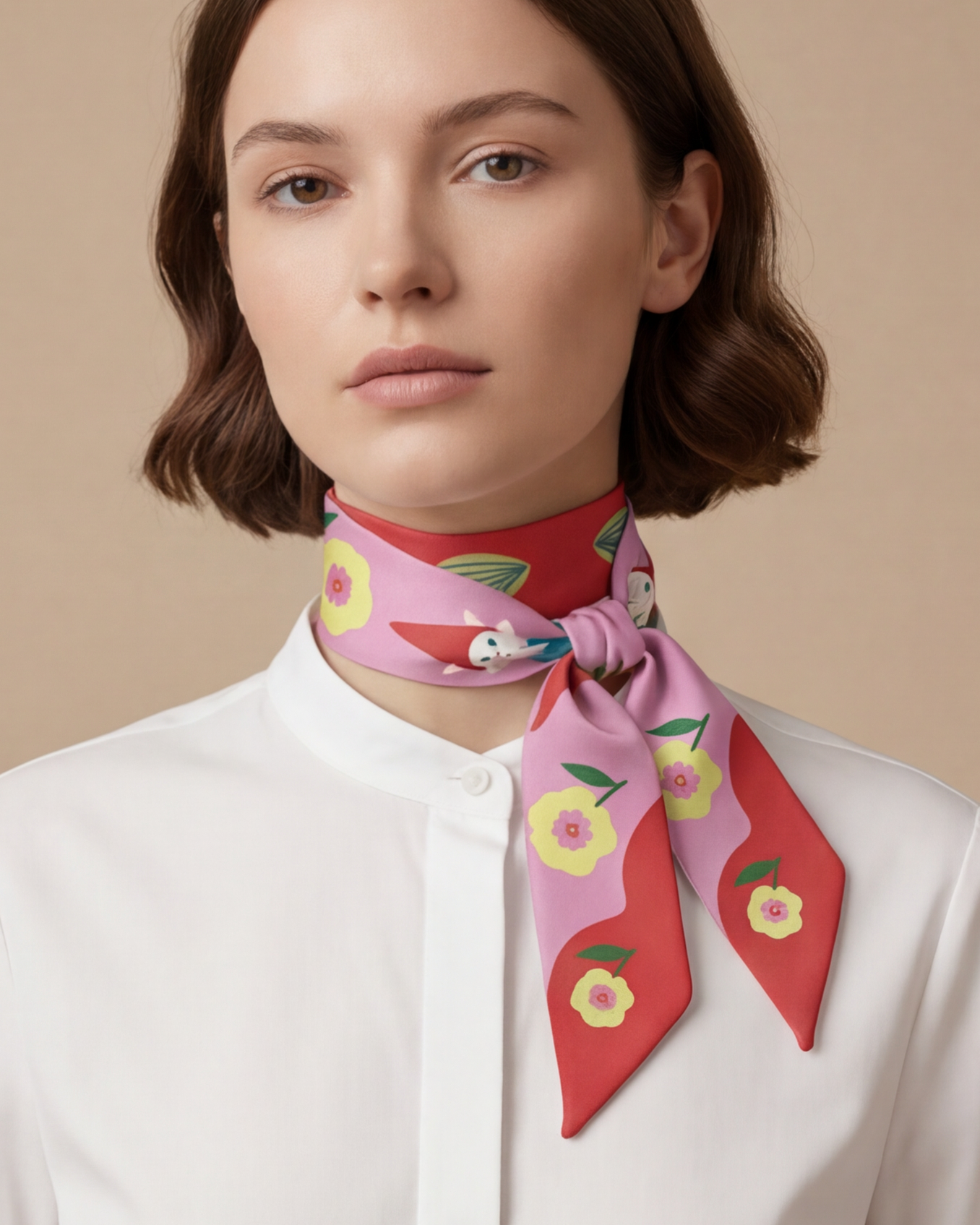 Woman wearing a colorful scarf with floral  and cat patterns on a beige background