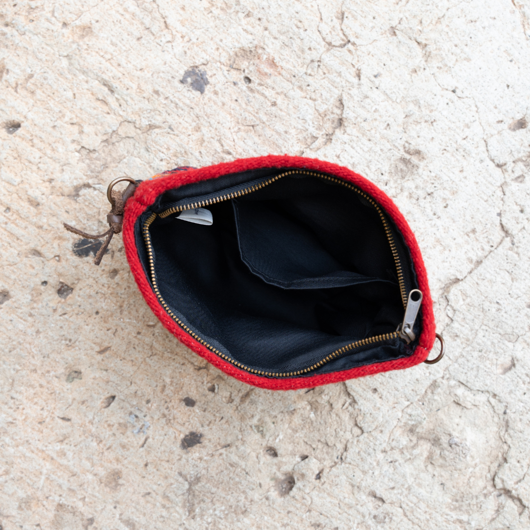 Interior view of Handwoven convertible clutch with Zapotec pattern in bold colors; can be used as a pouch, wristlet, or crossbody with included leather straps and internal pocket.