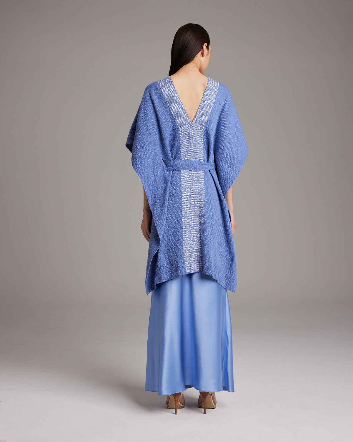 Back view of a blue Estrella Kaftan in textured cotton, with a belt.